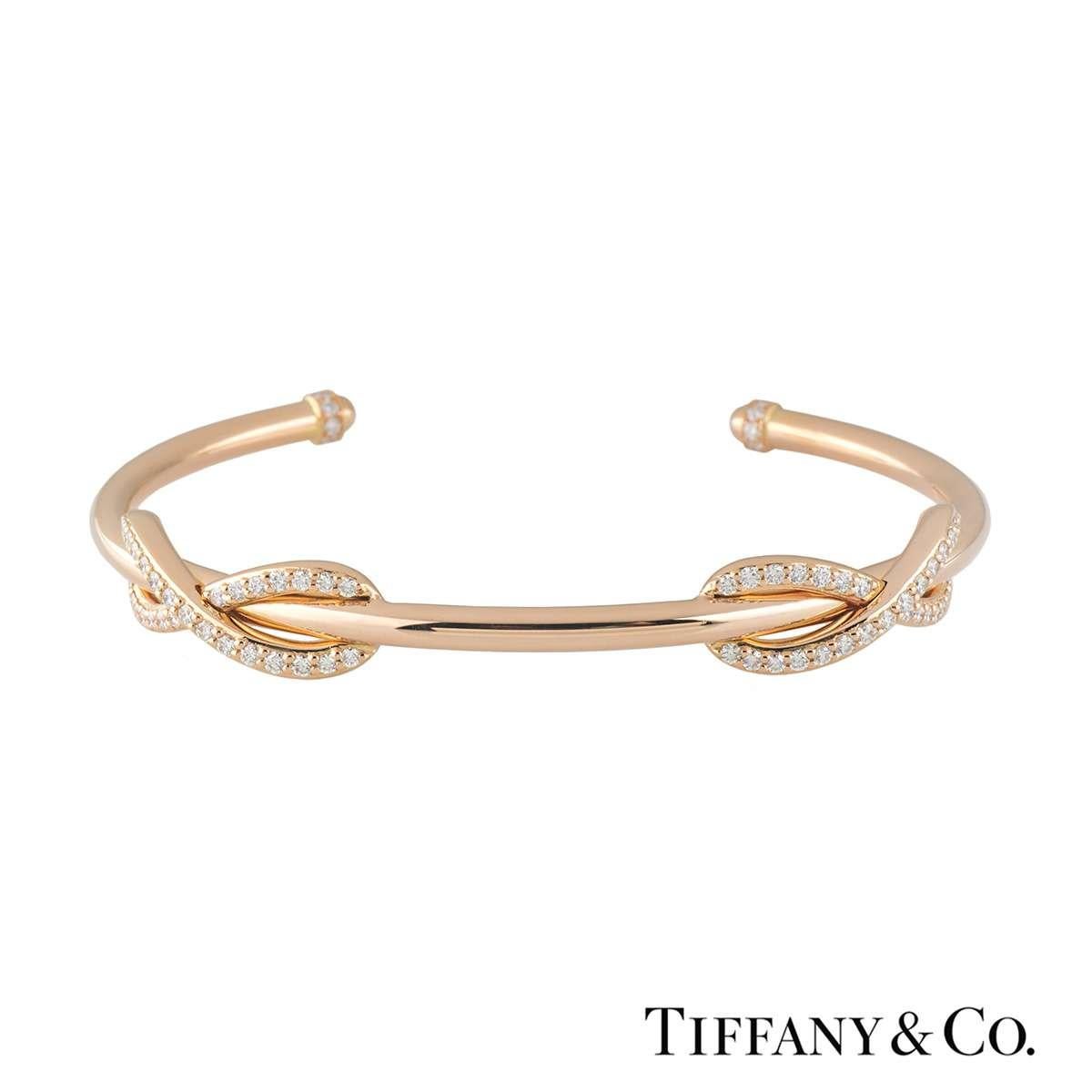 A stylish 18k rose gold diamond Tiffany & Co. cuff bangle from the Infinity collection. The bangle comprises of 2 infinity symbols encrusted with round brilliant cut diamonds totalling 0.65ct. The bangle would fit a wrist size of up to 6 inches and
