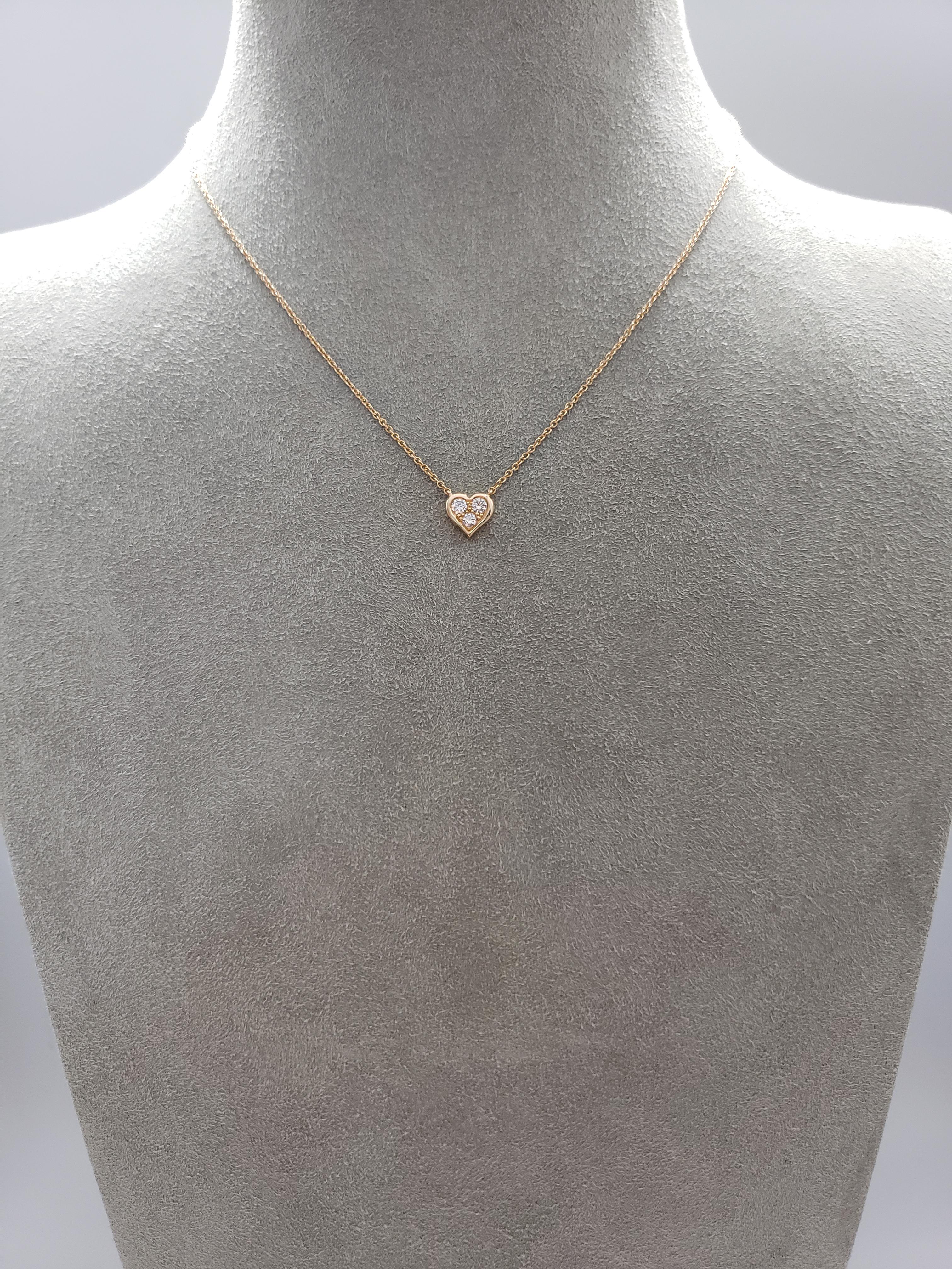 Made and signed by Tiffany & Co., features an 18 karat rose gold heart pendant set with 3 round brilliant diamonds weighing 0.17 carats total. Suspended on an 18 inch rose gold chain.