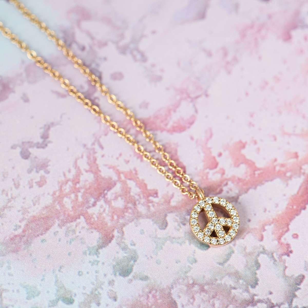An 18k rose gold diamond Peace pendant from the Metro collection by Tiffany & Co. The pendant features a diamond set Peace symbol, with 27 round brilliant cut diamonds totalling approximately 0.15ct. The pendant measures 7mm in diameter and comes on