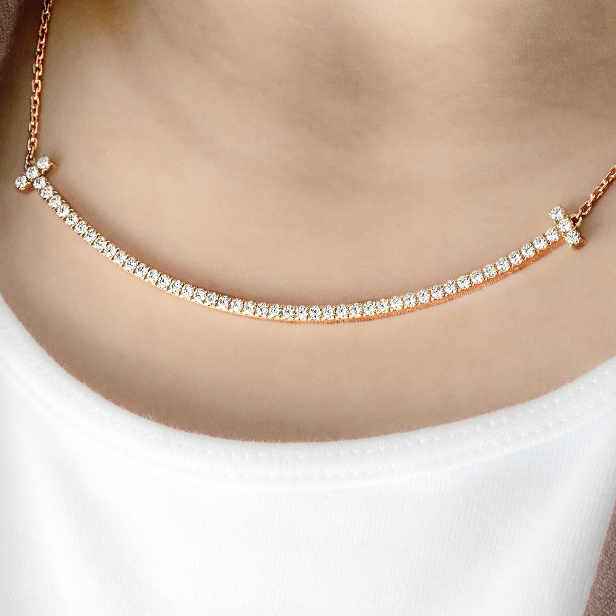 A charming 18k rose gold diamond Tiffany & Co. pendant from the Tiffany T Smile collection. The pendant comprises of a smile motif set with round brilliant cut diamonds with a total weight of 0.90ct. The pendant is presented on an adjustable 16-18
