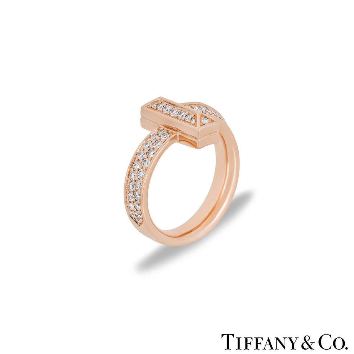 An extravagant 18k rose gold diamond ring by Tiffany & Co. from the Tiffany T collection. The diamond set T1 ring wraps around the finger with the iconic Tiffany T motif at the centre. The 61 round brilliant cut diamonds are pave set throughout with