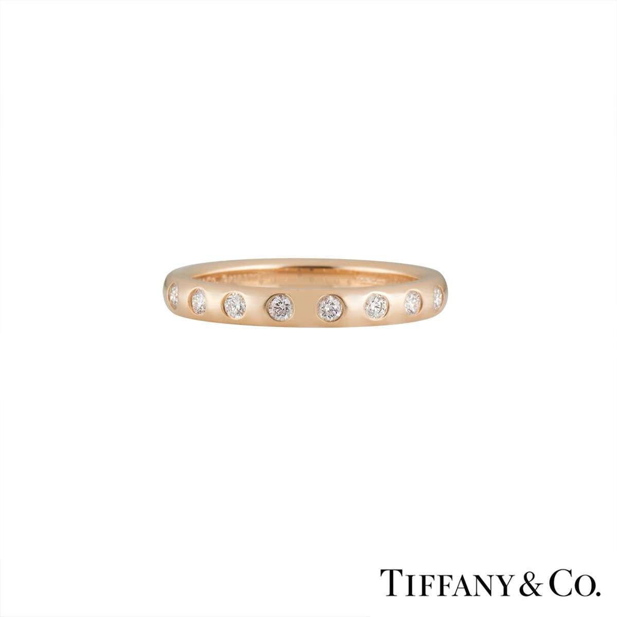 A delicate Tiffany & Co 18k rose gold stacking band from the Elsa Peretti collection. This ring has 8 round brilliant cut diamonds set across the front of the band totalling 0.16ct. This ring is currently a size UK L/US 5.5/EU51 but can be adjusted