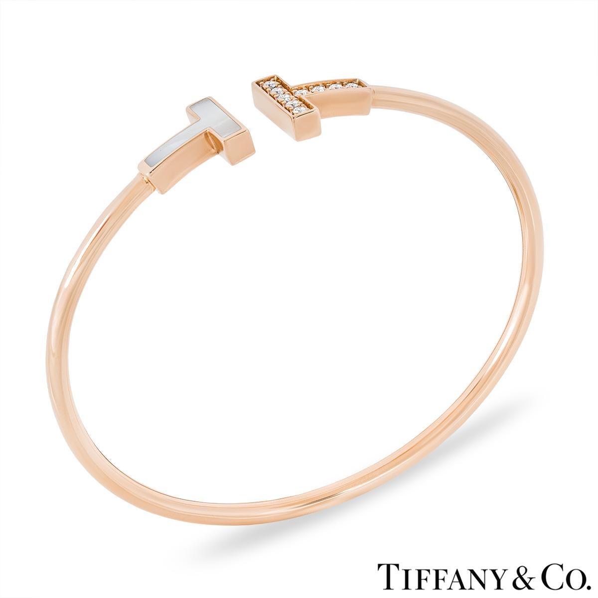 An elegant 18k rose gold mother of pearl and diamond bracelet by Tiffany & Co. from the Tiffany T collection. The cuff style bracelet comprises of two iconic Tiffany T motifs; the first is set with a mother of pearl inlay and the second is set with