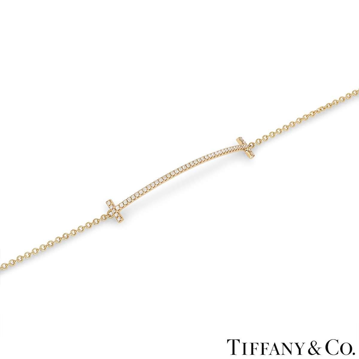 A delicate 18k rose gold diamond bracelet by Tiffany & Co. from the Tiffany T collection. The bracelet comprises of a curved design with the iconic Tiffany T at either end set to the centre and finishes with an adjustable trace chain and lobster
