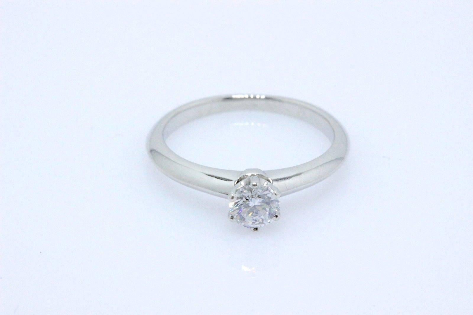 Tiffany & Co.
Style:  Tiffany 6-Prong  Classic Solitaire
Serial Number:  D56592
Metal:  Platinum PT950
Ring Size:  5 - Sizable
Total Carat Weight: 0.32 TCW
Diamond Shape:  Round Brilliant Diamond 0.32 CTS 
Color & Clarity: D / VVS2
Hallmark: 