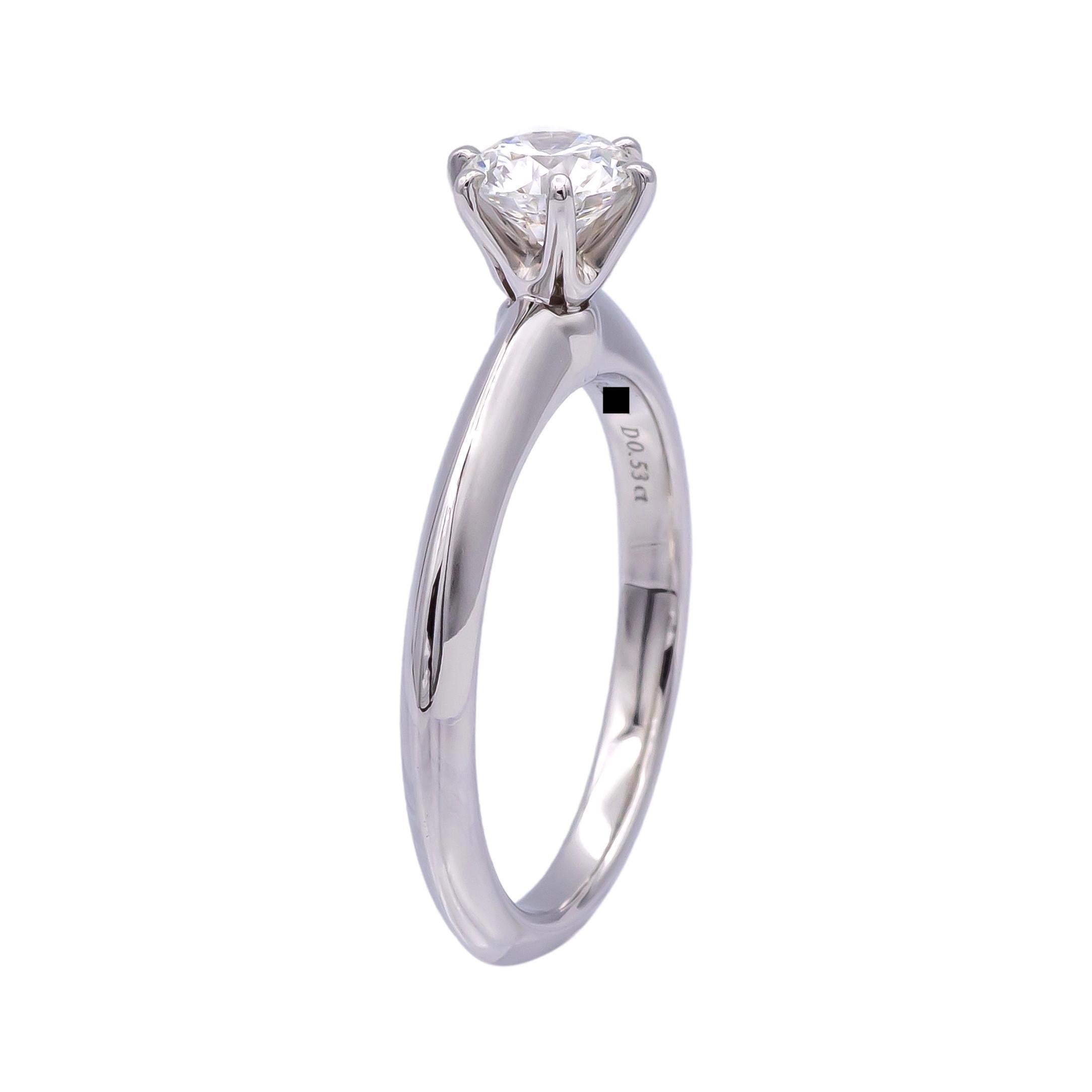 A 2019 Tiffany & Co Round Brilliant Diamond Solitaire featuring a .53 ct Center H VS1 diamond,  with a 'Triple Excellent' rating .  The diamond is set in Tiffany's most classic 6 prong Platinum Solitaire Mounting.  Included with the ring is the