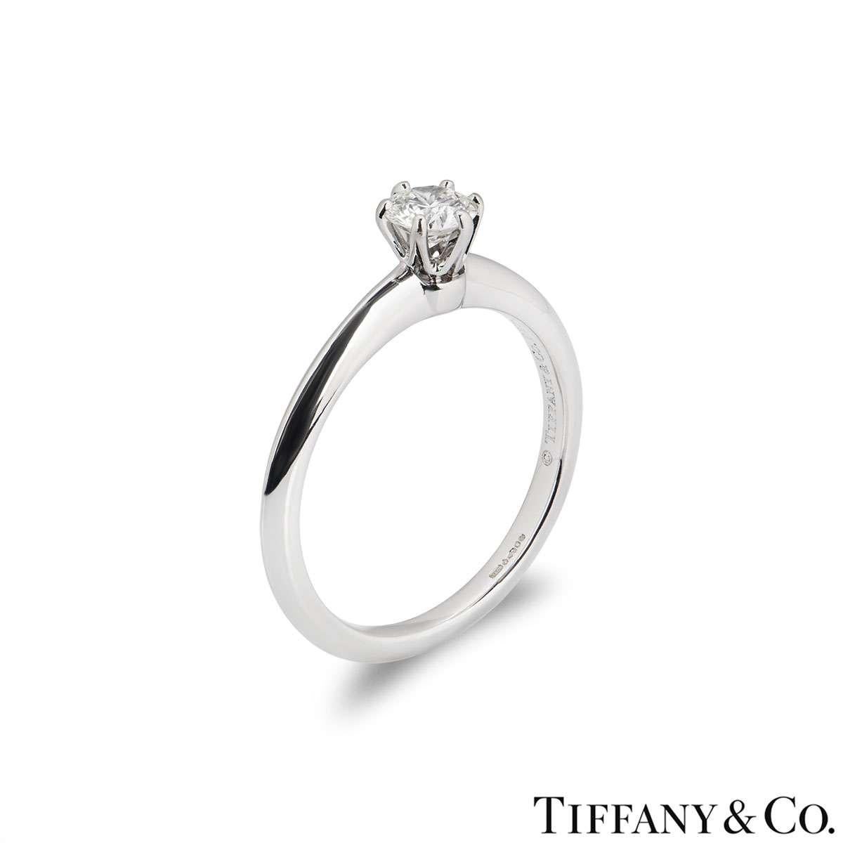A beautiful platinum diamond ring by Tiffany & Co. from The Setting collection. The ring comprises of a round brilliant cut diamond in a 6 claw setting with a weight of 0.32ct, H colour and VVS1 clarity. The diamond scores an excellent rating in all