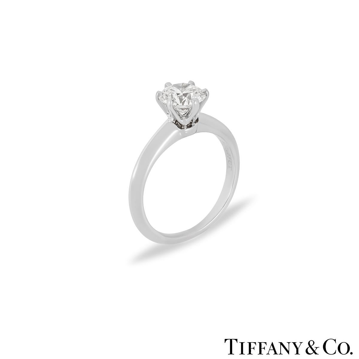 A stunning diamond ring in platinum by Tiffany & Co. The ring is set to the centre with a 1.05ct round brilliant cut diamond in a classic setting. The diamond is H colour and VS2 in clarity. The ring is currently a size J but can be adjusted for a