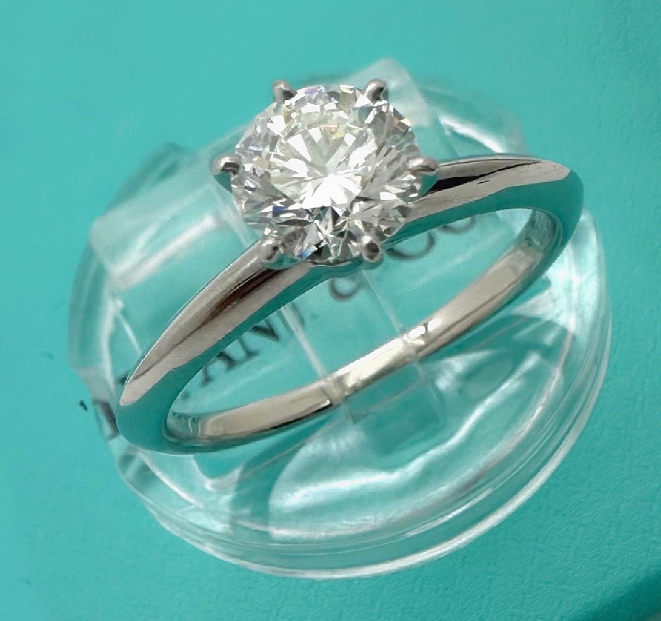 Tiffany & Co. Solitaire Diamond Engagement Ring
Style:  6-Prong
Ref. number:  38136909
Metal:  Platinum PT950
Size:  6.5 sizable
Band Width:  1.9 MM
Main Stone: Round Brilliant Diamonds 0.80 cts H color, VS1 clarity
Inscription:  Crown Inscription