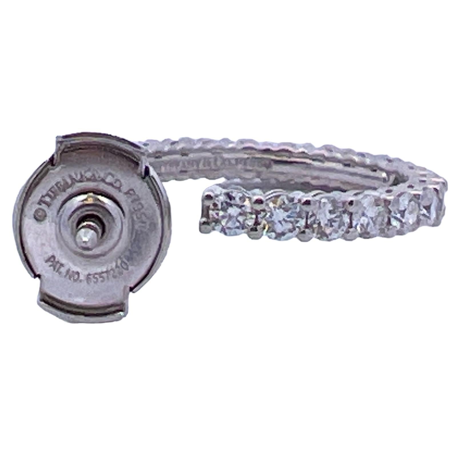 Classic diamond hoop earrings by Tiffany & Co. fashioned in platinum. The hoops feature 38 round brilliant cut diamonds weighing approximately 1.50 carat total weight. The diamonds are graded E-F color and VS clarity. The hoops measure 18mm in