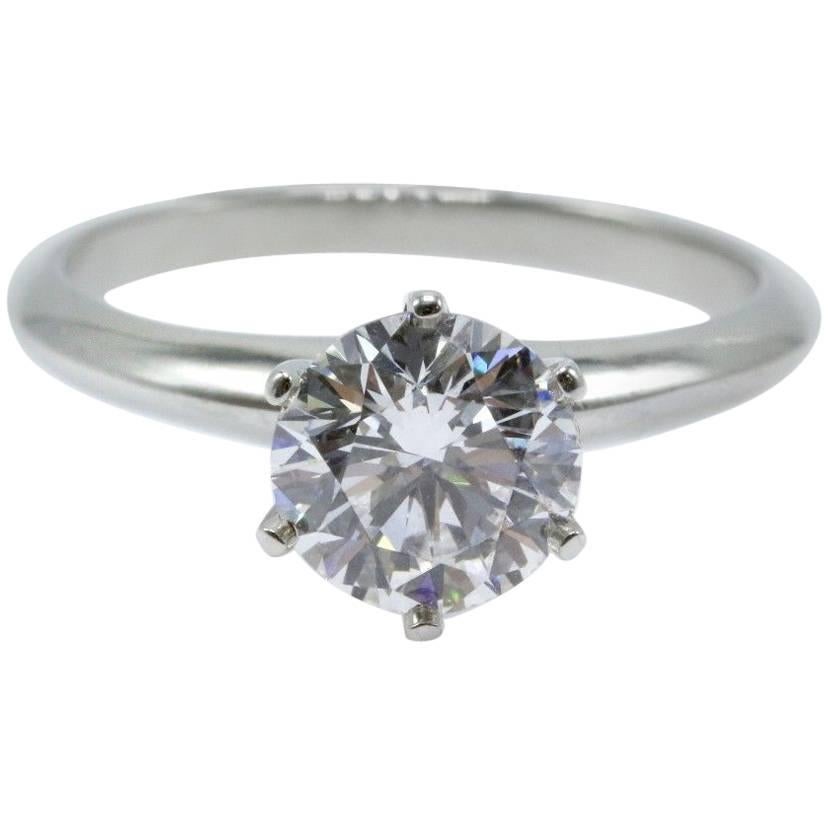 Tiffany & Co 
Classic 6 Prong Solitaire Platinum Engagement Ring.  
Round Brilliant Diamond Center is 1.29 CTS D color, VVS2 clarity.  
Ring is Hallmarked TIFFANY&CO.PT950 D25671 1.29
Size 6 - Sizable. 
Includes T&C Diamond Certificate, T&C Ring