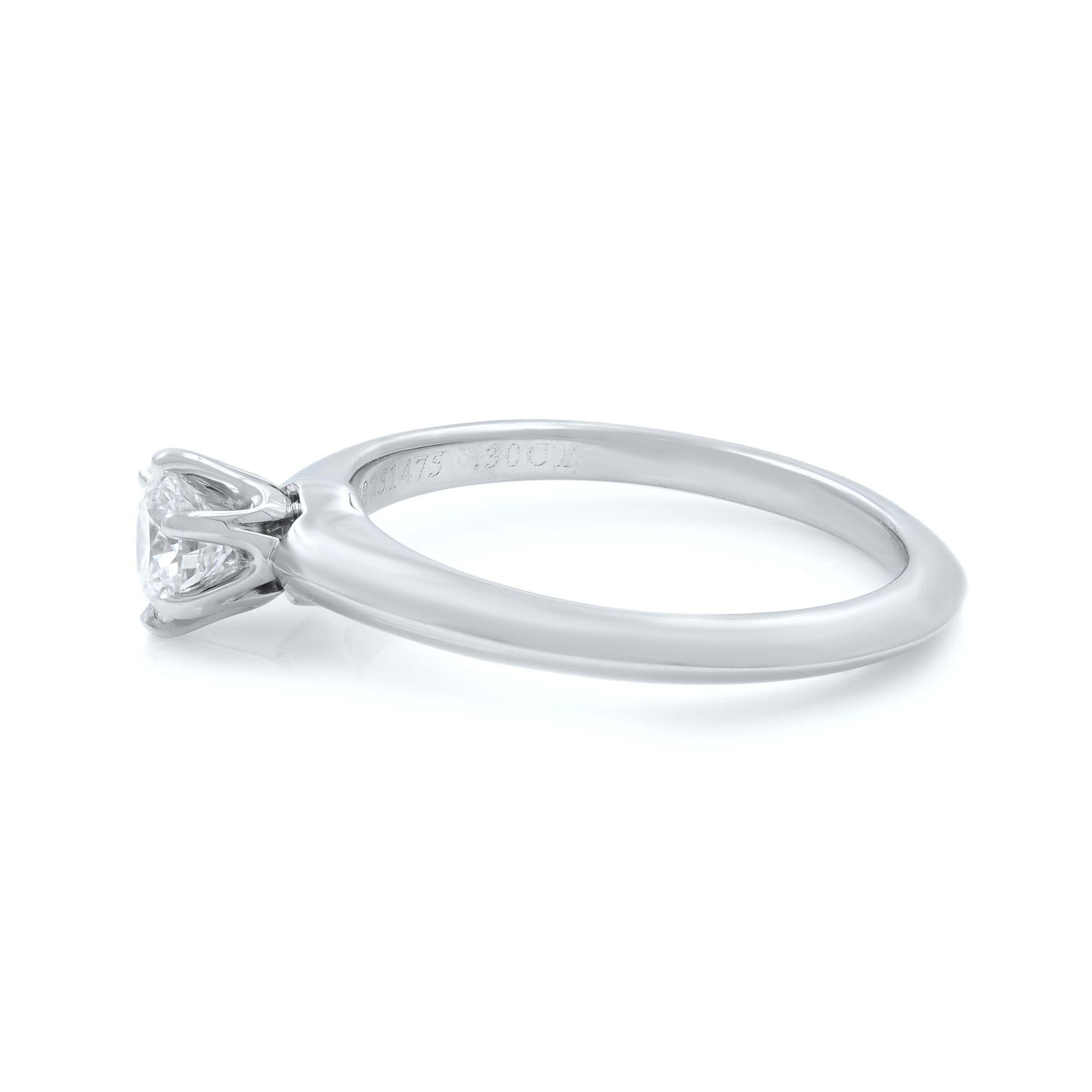 Tiffany & Co classic round cut solitaire diamond engagement ring crafted in platinum. This ring features prong set 0.30 carat of round brilliant cut diamond of G color and VS2 clarity. Hallmarked Tiffany & Co. Ring size 4. Can be resized at