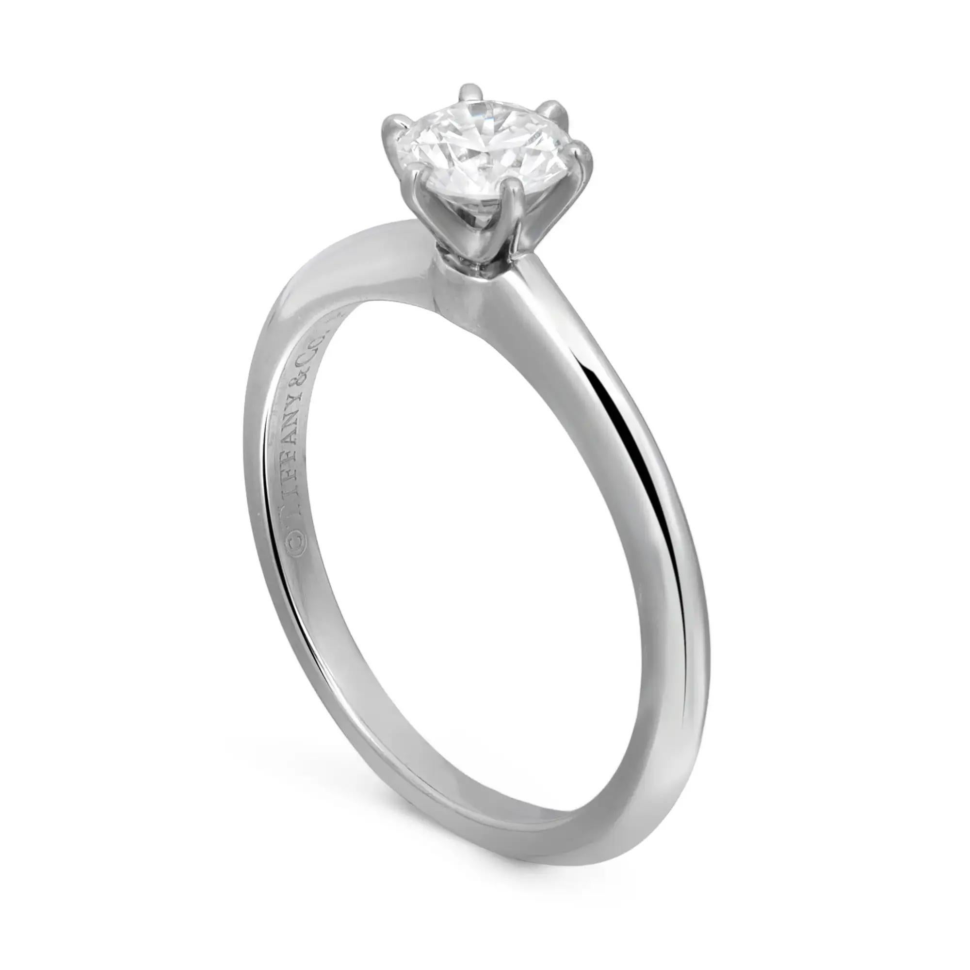 Beautiful Tiffany & Co. solitaire six prongs diamond engagement ring crafted in platinum, encrusted with center round brilliant cut diamond weighing 0.49 carat. Diamond quality: F-G color and VS1-VS2 clarity. Hallmarked Tiffany & Co. Ring size 5.5.