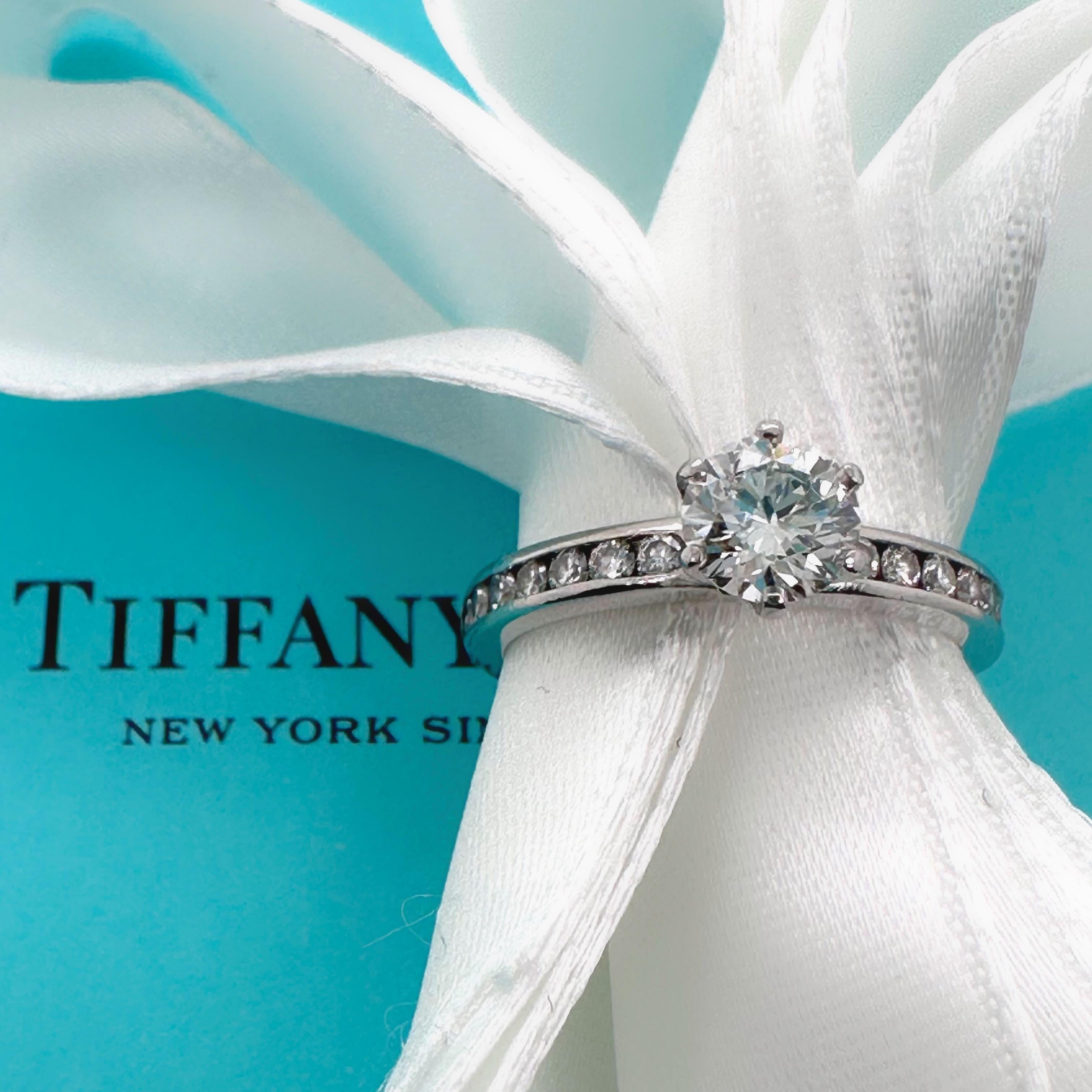 Tiffany & Co. Round Brilliant Diamond with Channel Set Band Engagement Ring
Style:  Channel Set 
Dia. number:  62890592/T03190476
Metal:  Platinum PT50
Size:  5.25 sizable
Measurements:  2.2 mm Band Width
TCW:  0.80 tcw
Main Diamond:  0.59 cts Round