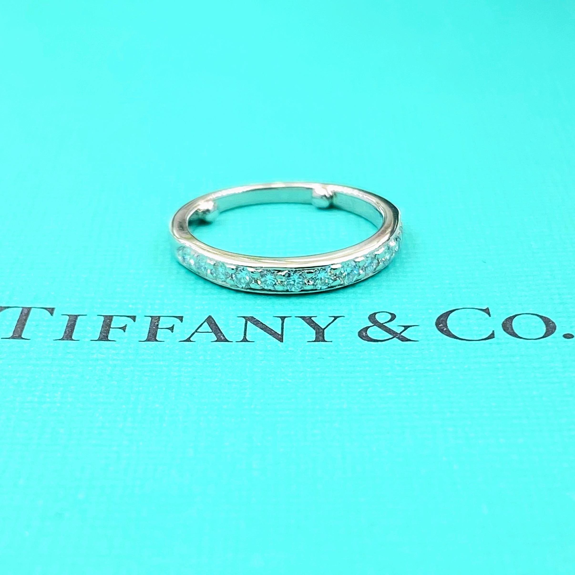 Tiffany & Co. Diamond Wedding Band Ring
Style:  Half-Circle Bead Set 
Metal:  Platinum PT950
Size:  4.5 w/ sizing beads - sizable
Measurements:  2.50 MM
TCW:  0.27 tcw
Main Diamond:  13 Round Brilliant Diamonds
Color & Clarity:  F - G /