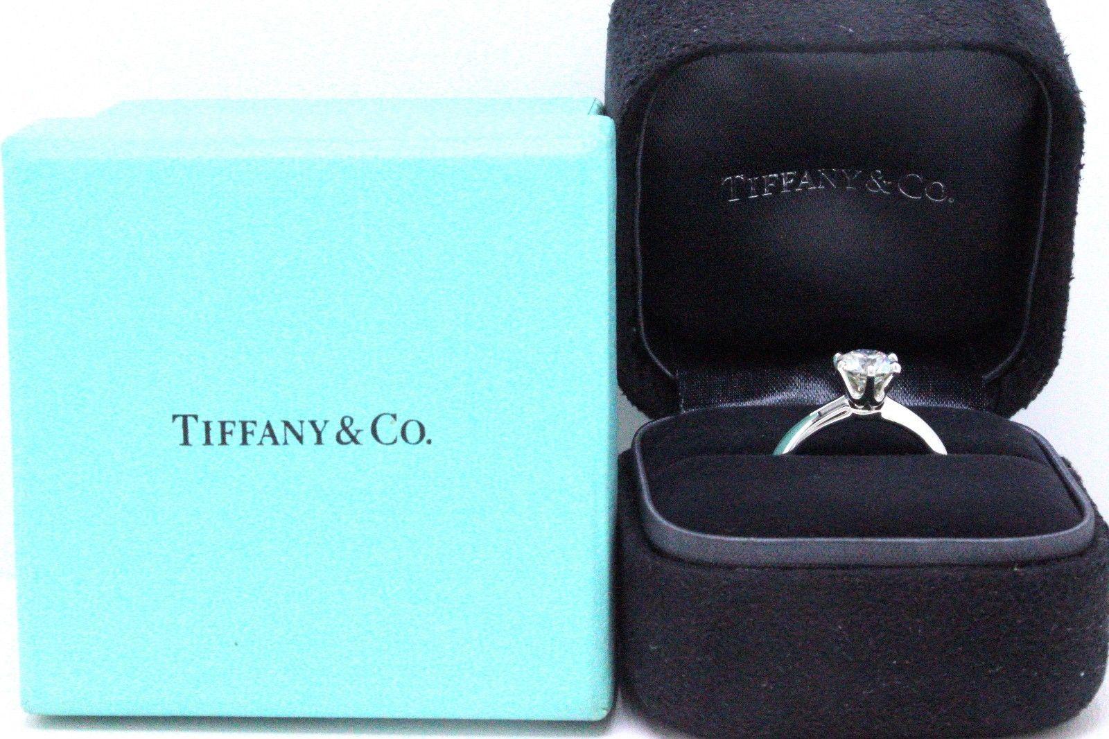 Tiffany & Co.

Style:  Solitaire Diamond Engagement Ring
Serial Number:  G11140039 / 21487848
Metal:  Platinum PT 950
Size:  5.5 - Sizable
Total Carat Weight:  1.07 CTS
Diamond Shape:  Round Brilliant
Diamond Color & Clarity:  F / VS1
Hallmark: 