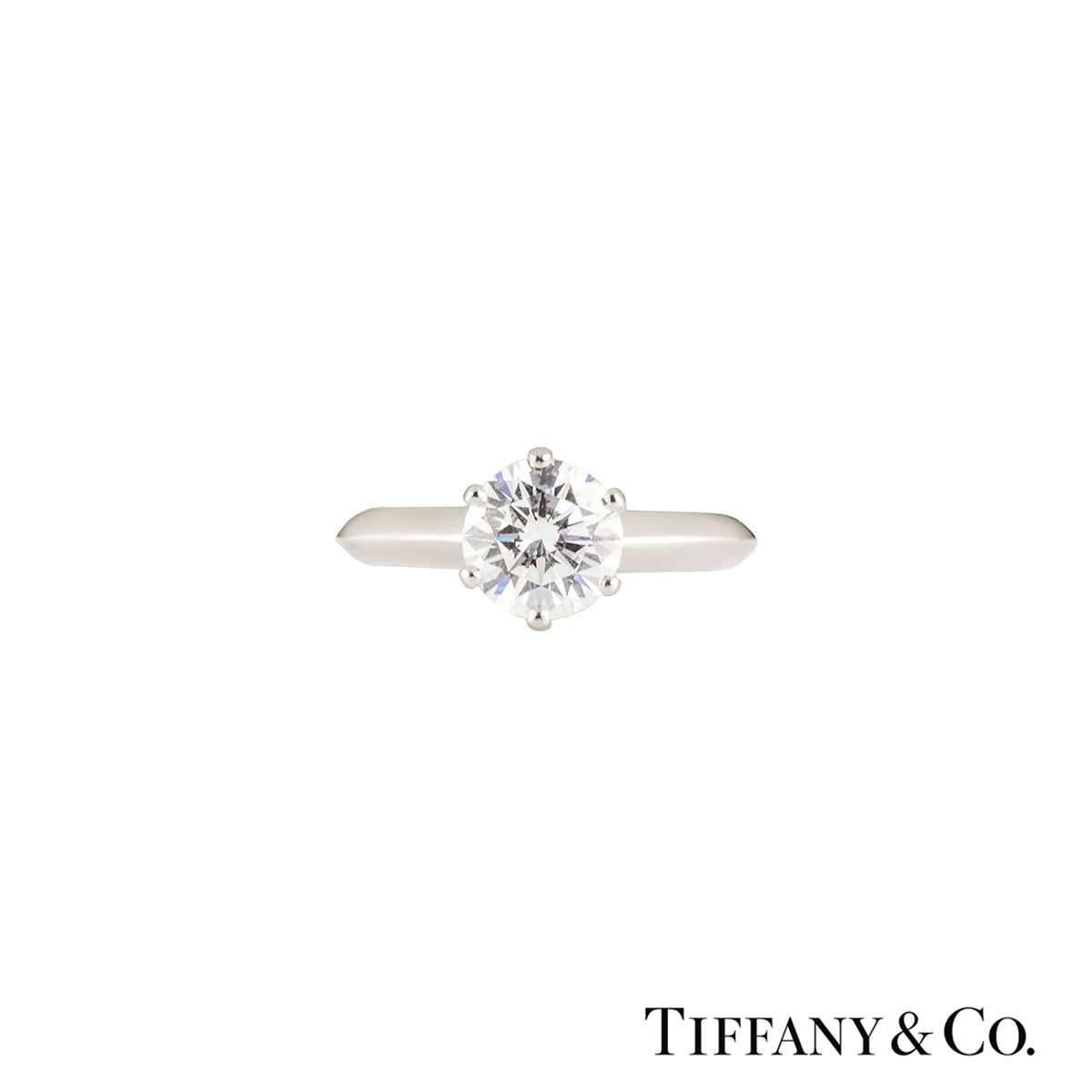 A classic Tiffany & Co. diamond engagement ring from The Tiffany Setting Band collection. The ring comprises of a round brilliant cut diamonds in a prong setting with a weight of 1.05ct, G colour and VVS1 clarity. The ring is a size UK G, US 3 3/8,