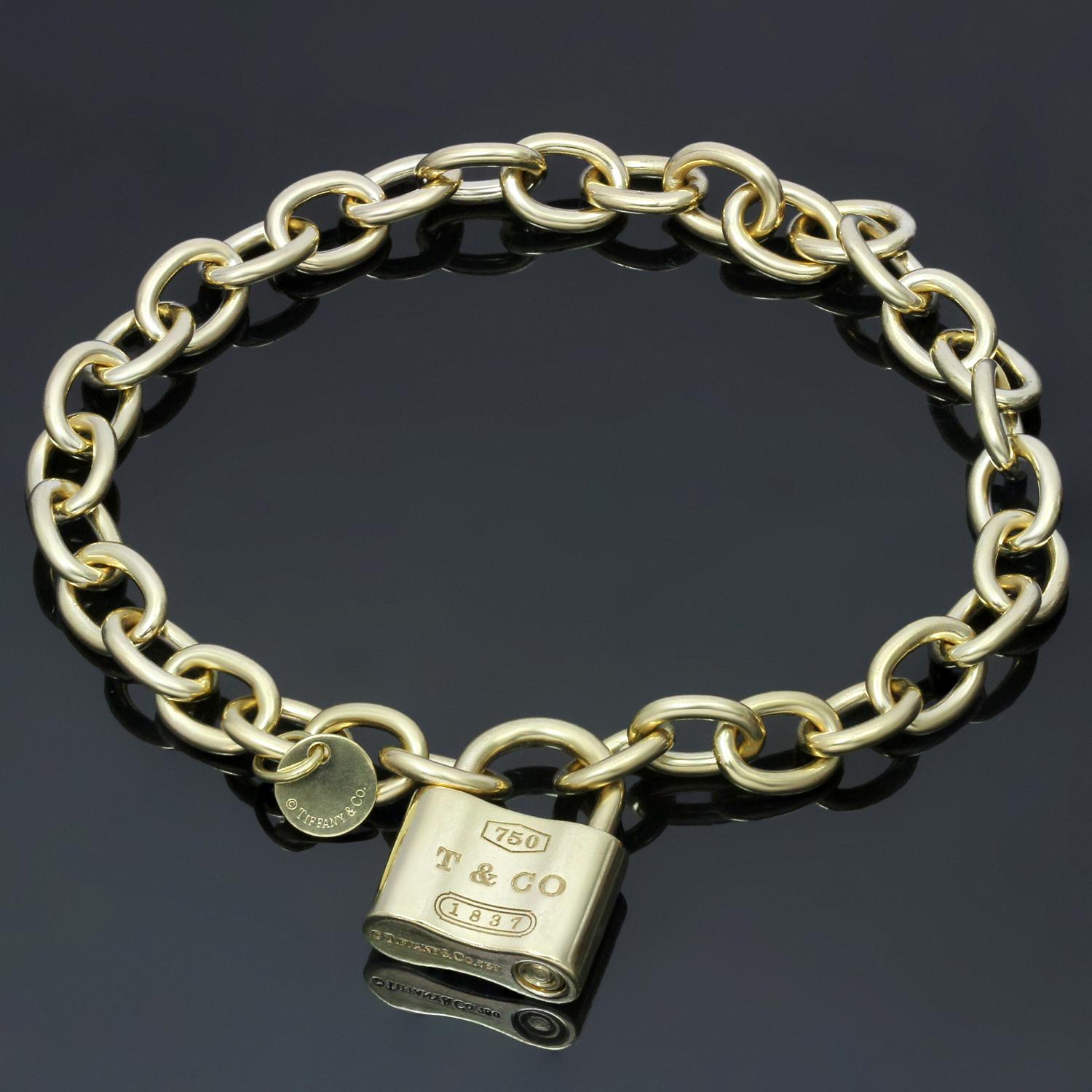 This chic Tiffany bracelet is crafted in 18k yellow gold and features a round link chain completed with an elegant lock-shaped signed clasp. Made in United States circa 2000s. Measurements: 0.75