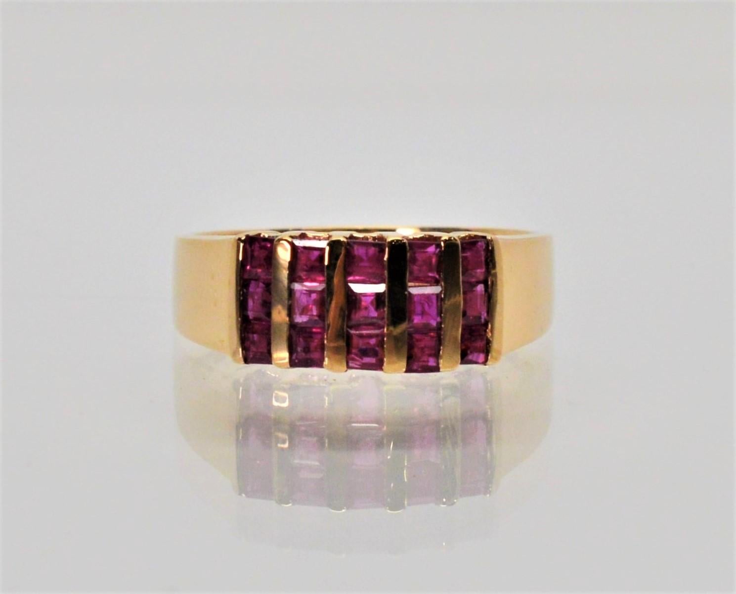 Fifteen natural  .01 rubies are set in a modern vertical arrangement to create this Tiffany & Co. jeweled band in fourteen karat yellow gold.
Stamped by maker. Size 6-7/8. In gift box.  