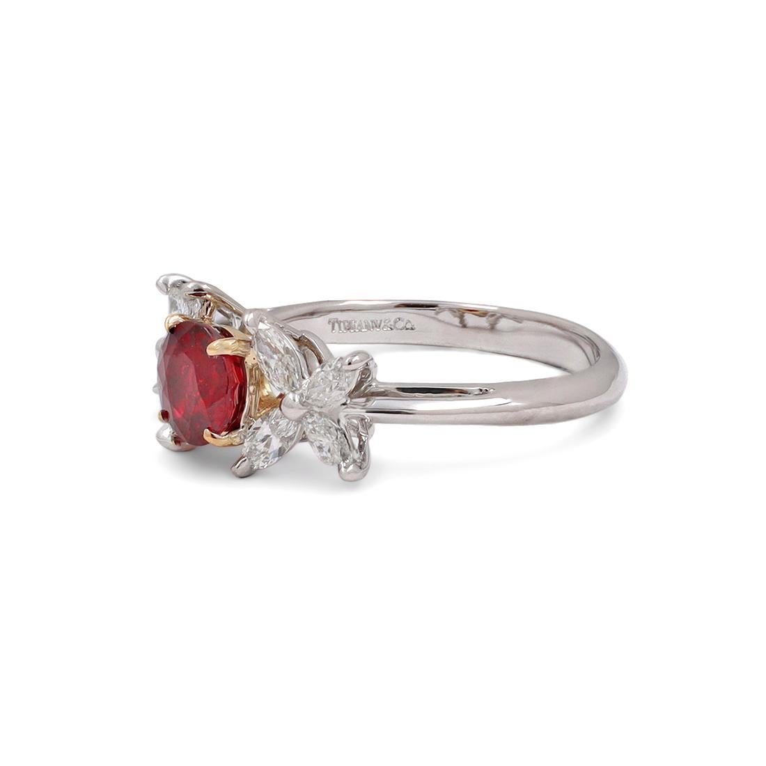 Authentic Tiffany & Co. 'Victoria' ring crafted in platinum and 18 karat yellow gold. This exquisite ring is set with two sparking marquise-shaped diamonds estimated at 0.60 carat total weight and one round brilliant cut ruby estimated 0.43 carat