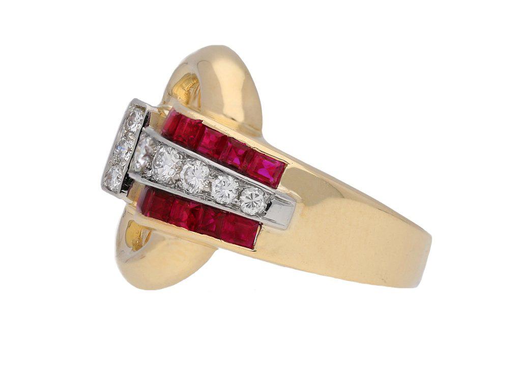 Tiffany & Co ruby cocktail buckle ring. Set with eight round old cut diamonds in open back grain settings with a combined approximate weight of 0.40 carats, and thirteen rectangular baguette cut natural unenhanced rubies in open back rubover channel