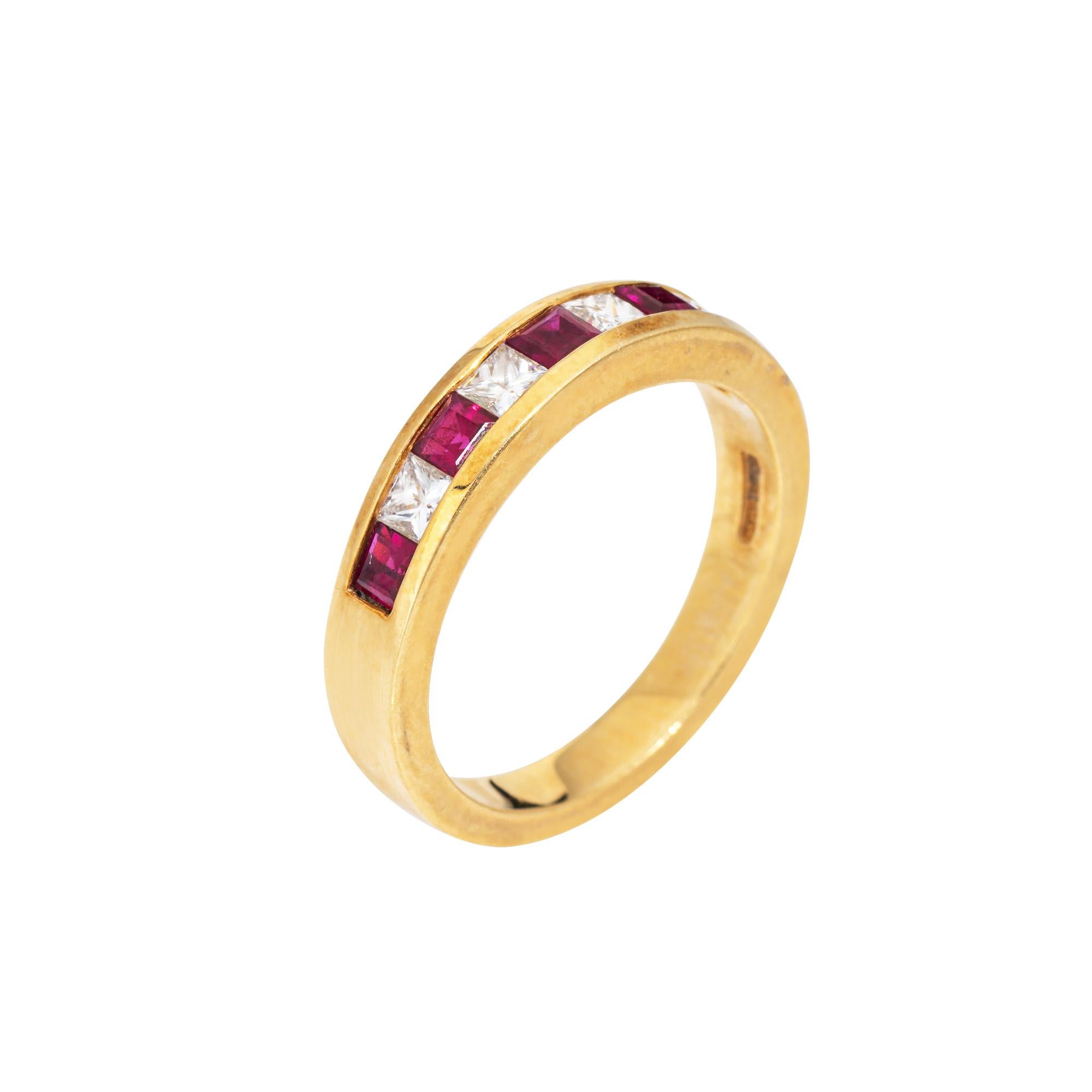 Vintage Tiffany & Co diamond & ruby ring crafted in 18k yellow gold (circa 1990s).  

4 princess cut diamonds total an estimated 0.20 carats (estimated at F-G color and VS1-2 clarity). Five square cut rubies measure approx. 2mm each. 

Set with an