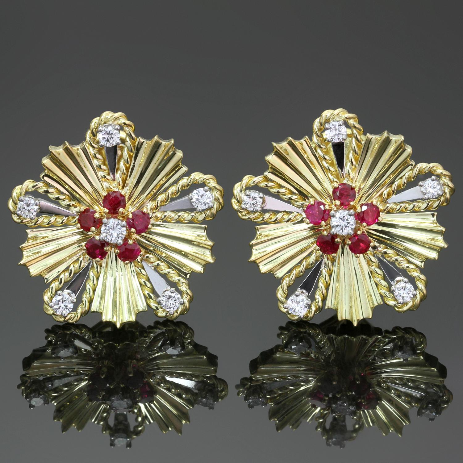 These gorgeous mid-20th century vintage Tiffany & Co. earrings feature an elegant starburst design crafted in 18k yellow gold and set with deep red sparkling rubies and brilliant-cut round F-G VS1-VS2 diamonds weighing an estimated 0.60 carats. Made