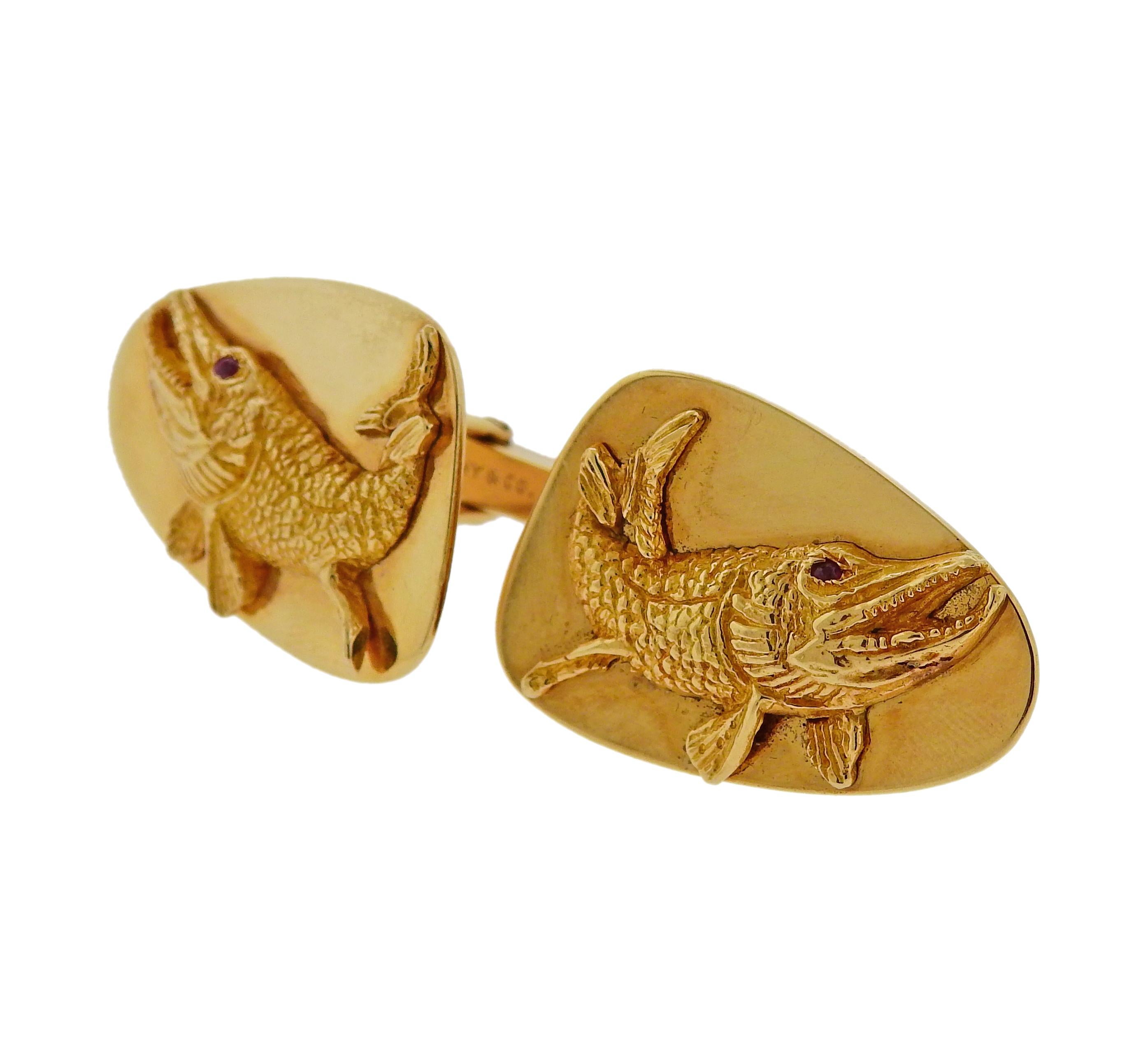 Pair of large 14k gold cufflinks by Tiffany & Co, depicting fish with ruby eyes. Each top measures 32mm x 22mm. Marked Tiffany & Co, 14k. Weigh 28.1 grams.

SKU#C-00155