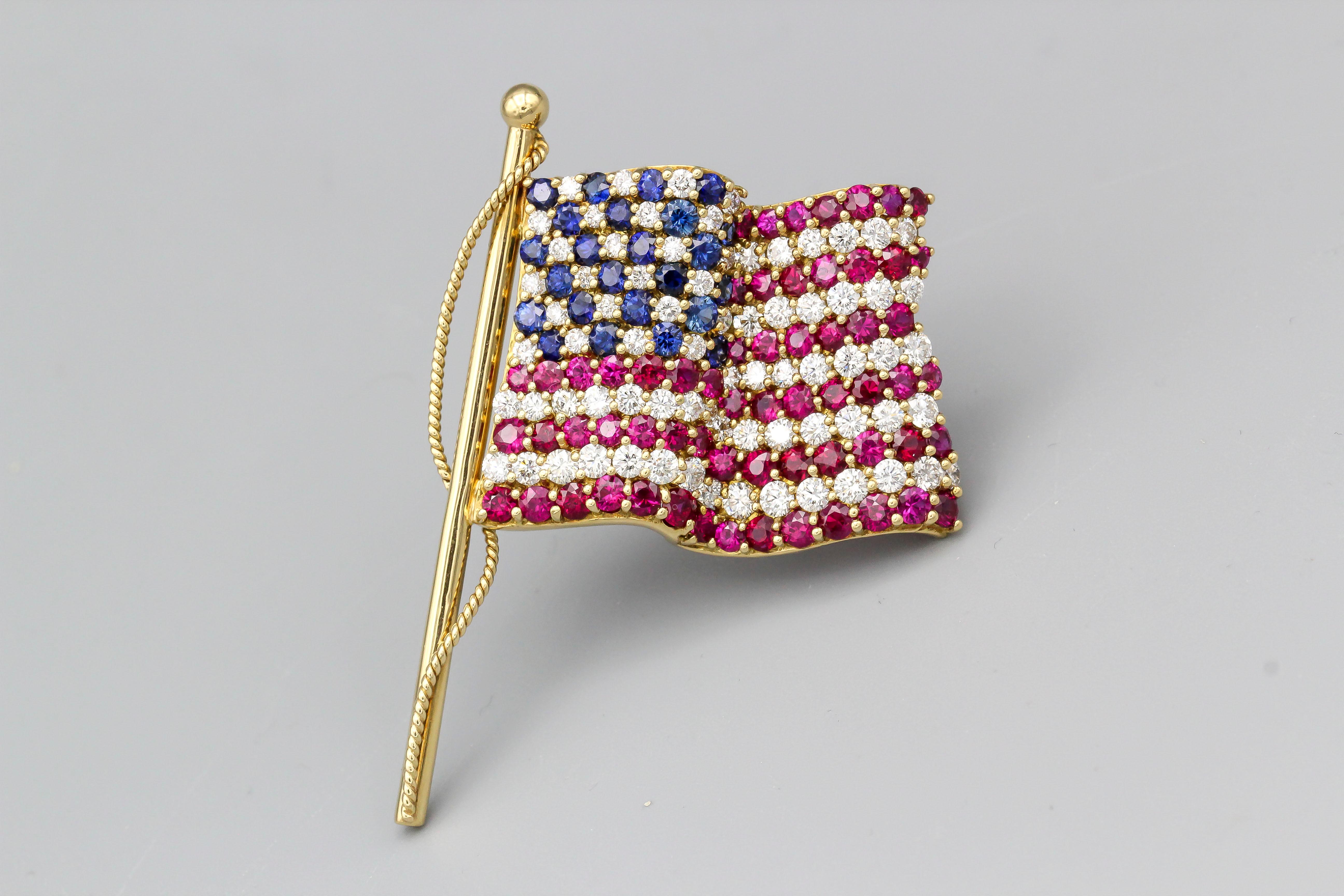 Very fine ruby, sapphire, and diamond brooch set in 18k yellow gold by Tiffany & Co., circa 2001. Featuring vibrant colors and waving flag design. 

Hallmarks: Tiffany & Co., 2001, 750.