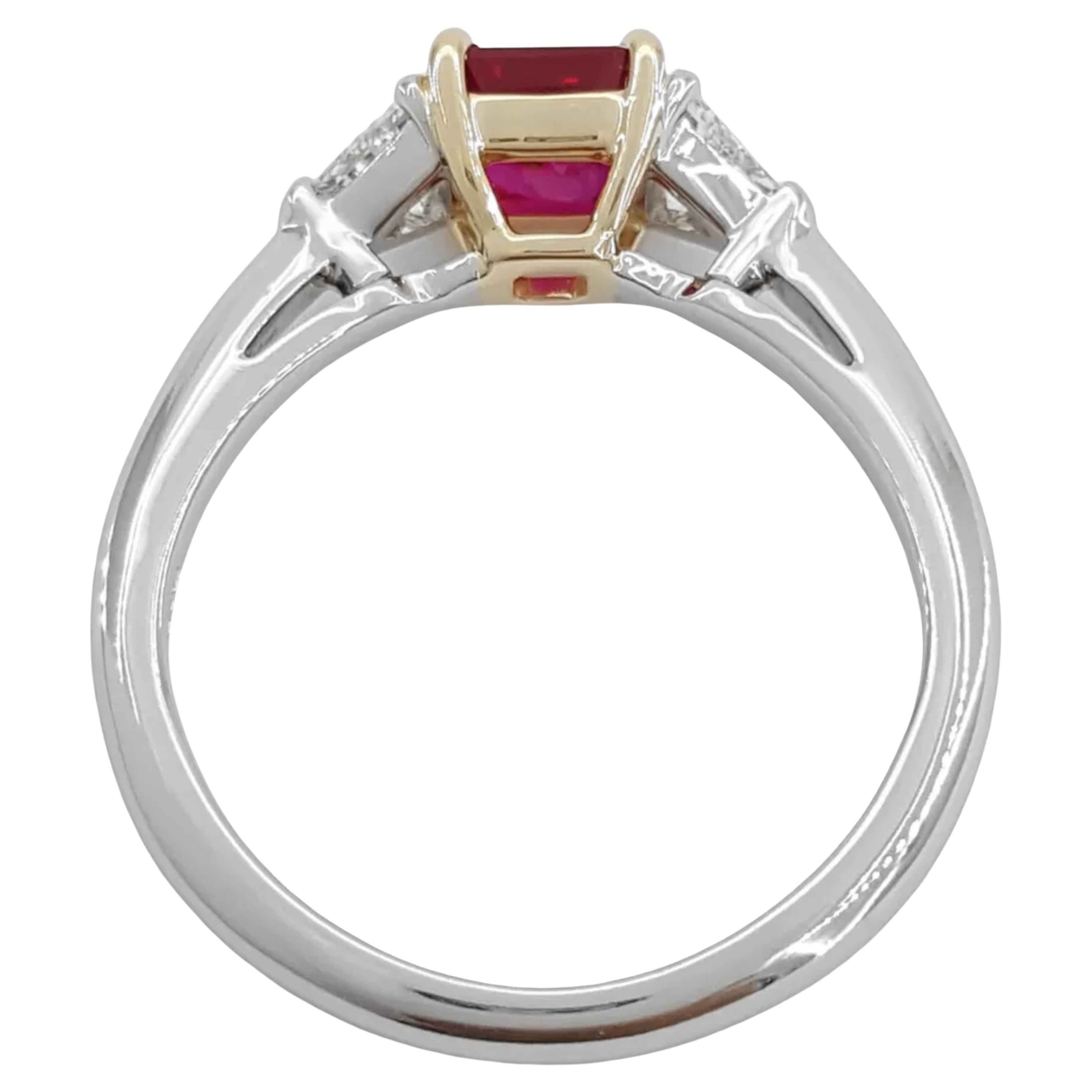 Tiffany & Co. ring features a stunning three-stone design, highlighted by a natural square asscher cut ruby at its center. Weighing approximately 1.10 carats, the ruby exhibits a vivid color and is known for its remarkable clarity, measuring 5.58 x