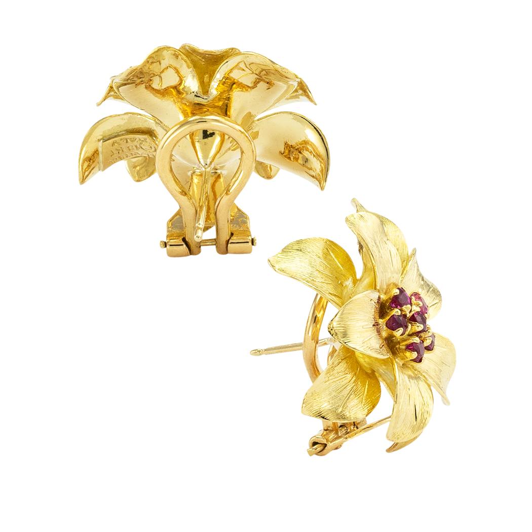 Tiffany & Co ruby and gold clip-on flower earrings circa 1960. *

ABOUT THIS ITEM:  #E-DJ71B. Scroll down for specifications.  These beautiful figural designs of delicate flowers showcase clusters of round faceted rubies centering richly textured