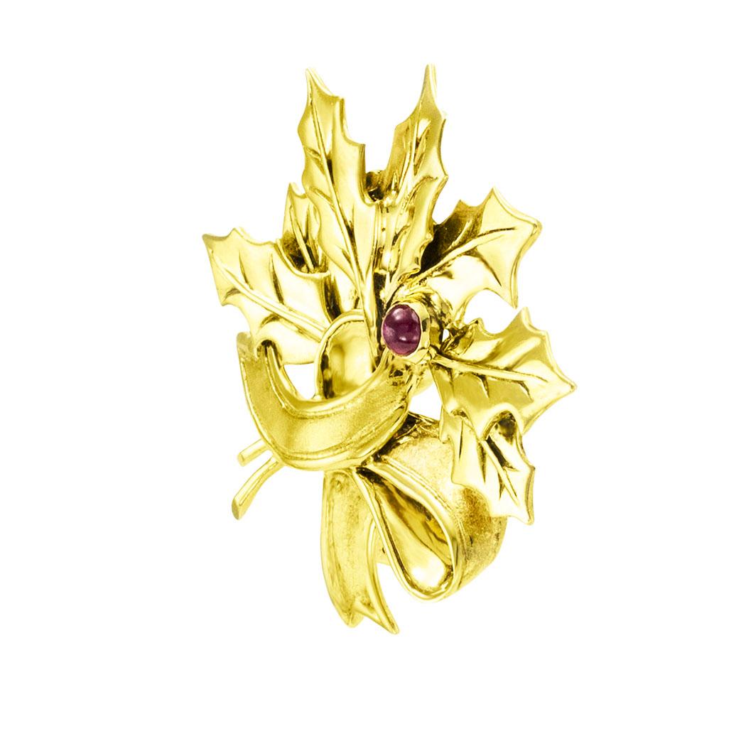 Tiffany & Co ruby and yellow gold holly leaf brooch circa 1980. *

ABOUT THIS ITEM:  #P5040. Scroll down for specifications.  A Tiffany & Co. creation depicting holly leaves accented by a single ruby and gathered by an entwined ribbon of gold.  It
