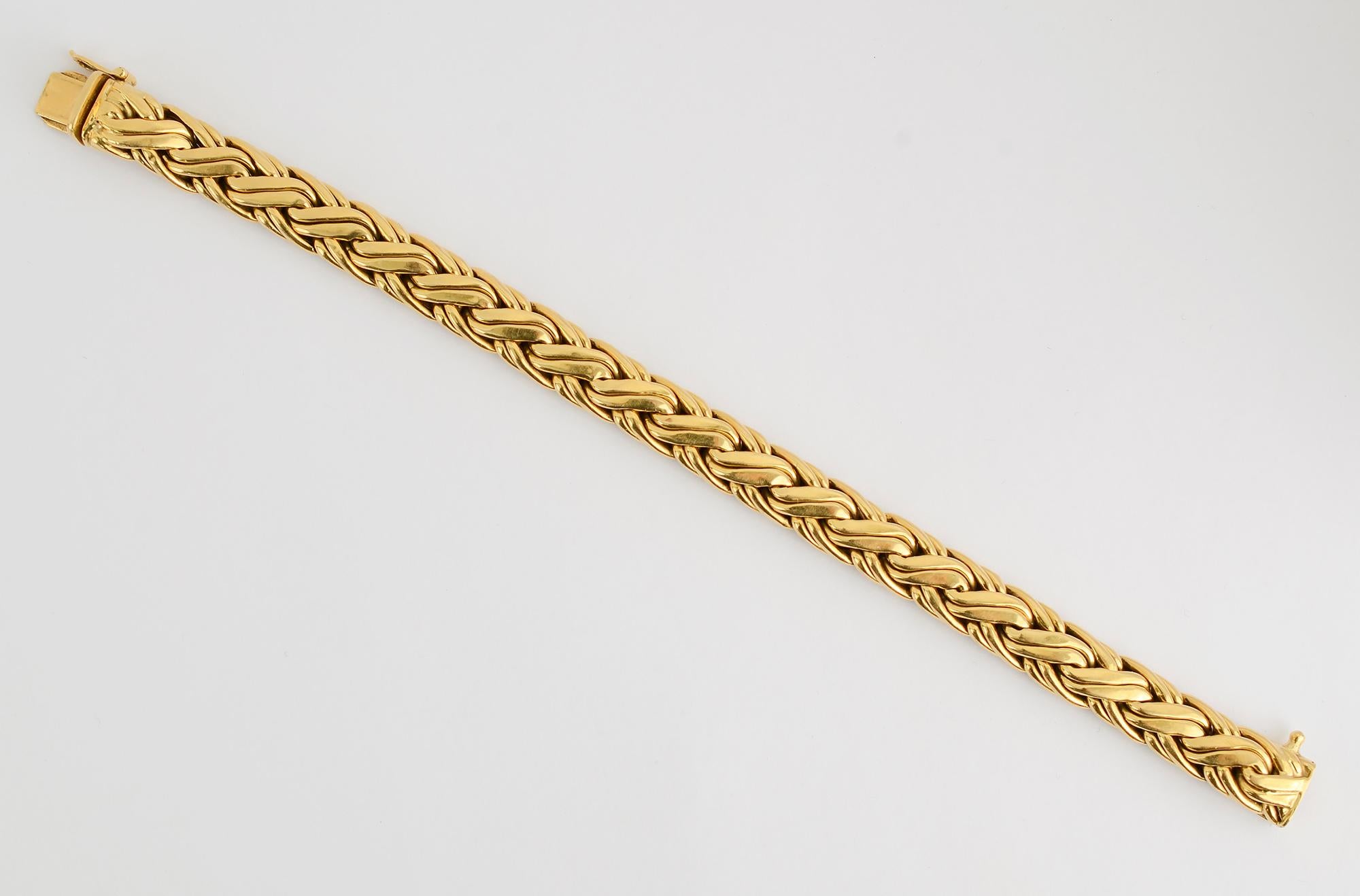 Intricately woven Russian braid bracelet by Tiffany. It is beautifully made of 18 karat gold with a safety latch in addition to the push clasp. The bracelet is 7 1/4 inches long and 3/8 inch wide. 
This bracelet is perfect worn either by itself or