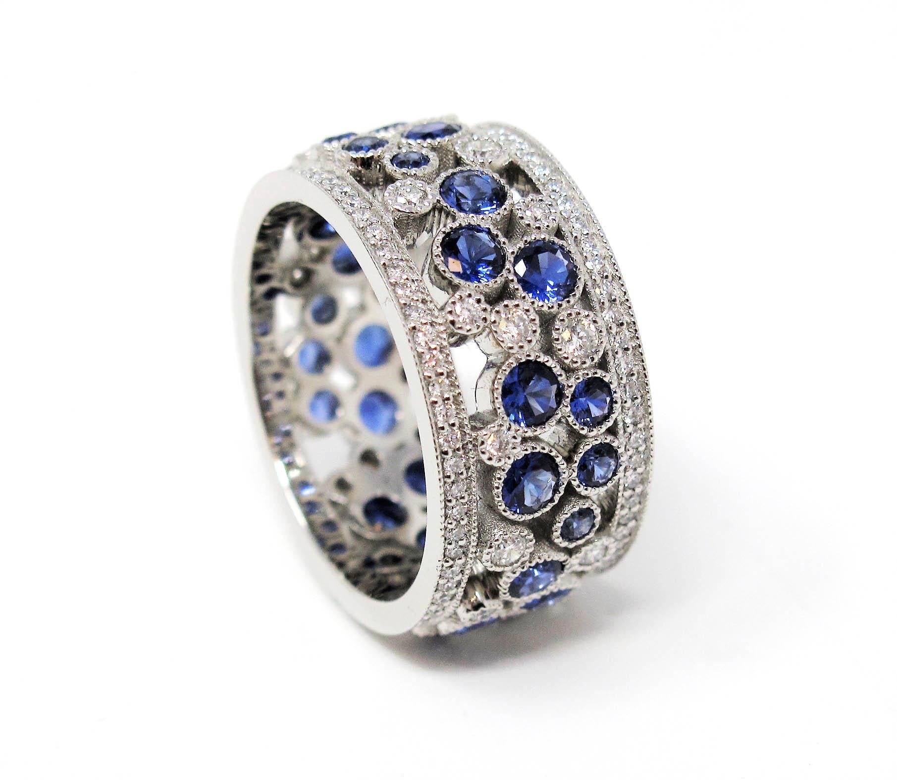 Stunningly sparkly Cobblestone band ring from Tiffany & Co. This amazing piece is filled with  dazzling white diamonds and sparkling blue sapphires set in a playful path of cobblestones throughout the ring. You'll simply adore how these exceptional
