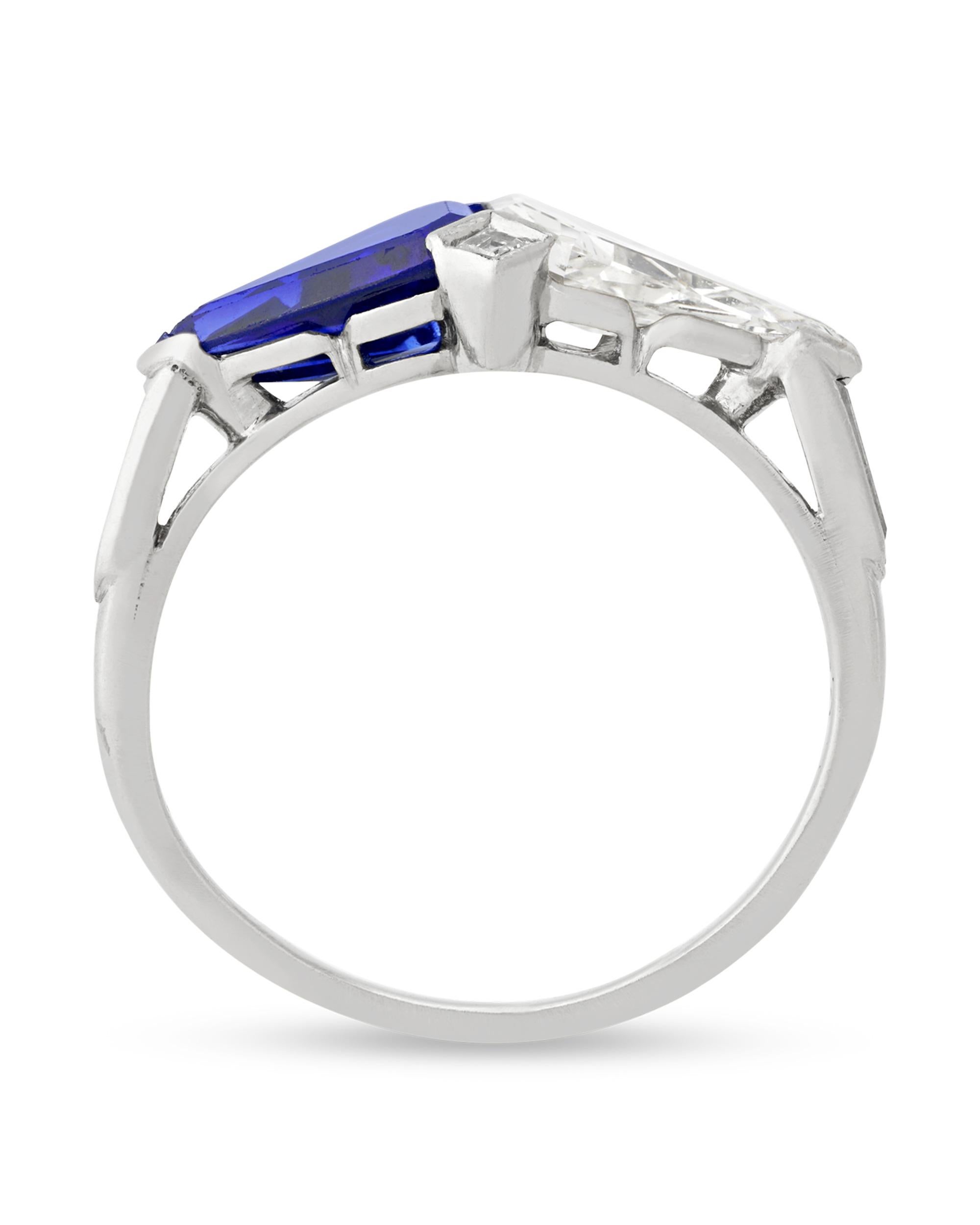 Crafted by the iconic jeweler Tiffany & Co., this beautiful east-west style ring combines a ravishing 1.27-carat royal blue sapphire with a sparkling 1.27-carat white diamond. Each of the gems is cut into a kite shape and placed side by side for a