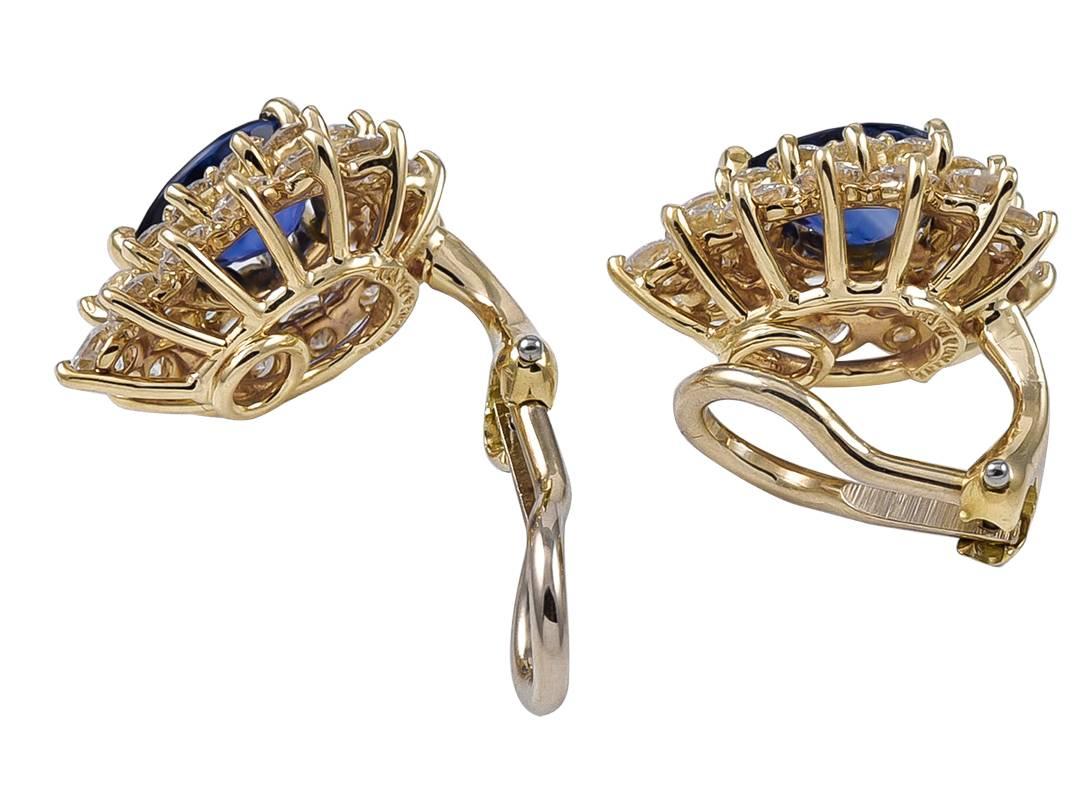 Spectacular brilliant ear clips.  Hand-made and signed by TIFFANY & CO.  In the centers are two perfectly matched bright, vivid sapphires totaling 2 cts.  Surrounded by approximately 2.25 cts. of near colorless diamonds,  F-G/VS.  18K yellow gold. 