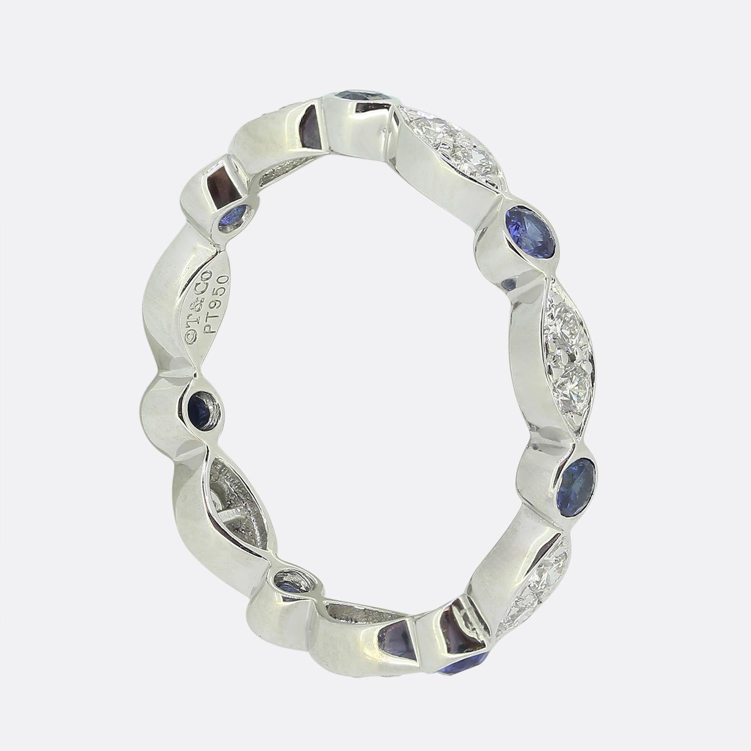 Here we have an iconic eternity ring from the world renowned luxury jewellery designer, Tiffany & Co. This piece forms part of their Jazz collection and showcases an alternating sequence of blue sapphires and paired round brilliant cut diamonds.