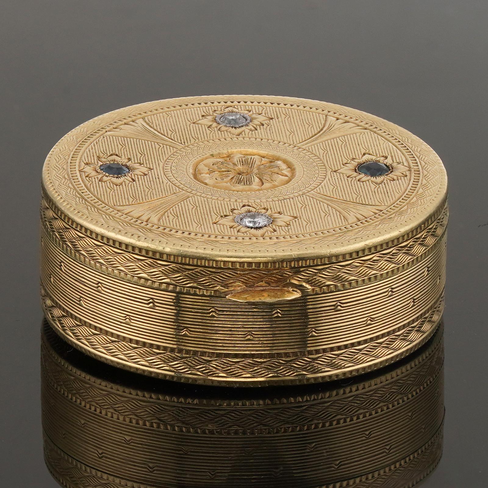 This rare antique Tiffany & Co. pill box features a filigree design crafted in 14k yellow gold and set with diamonds and blue sapphire. Made in United States circa 1940s. Measurements: 1.18