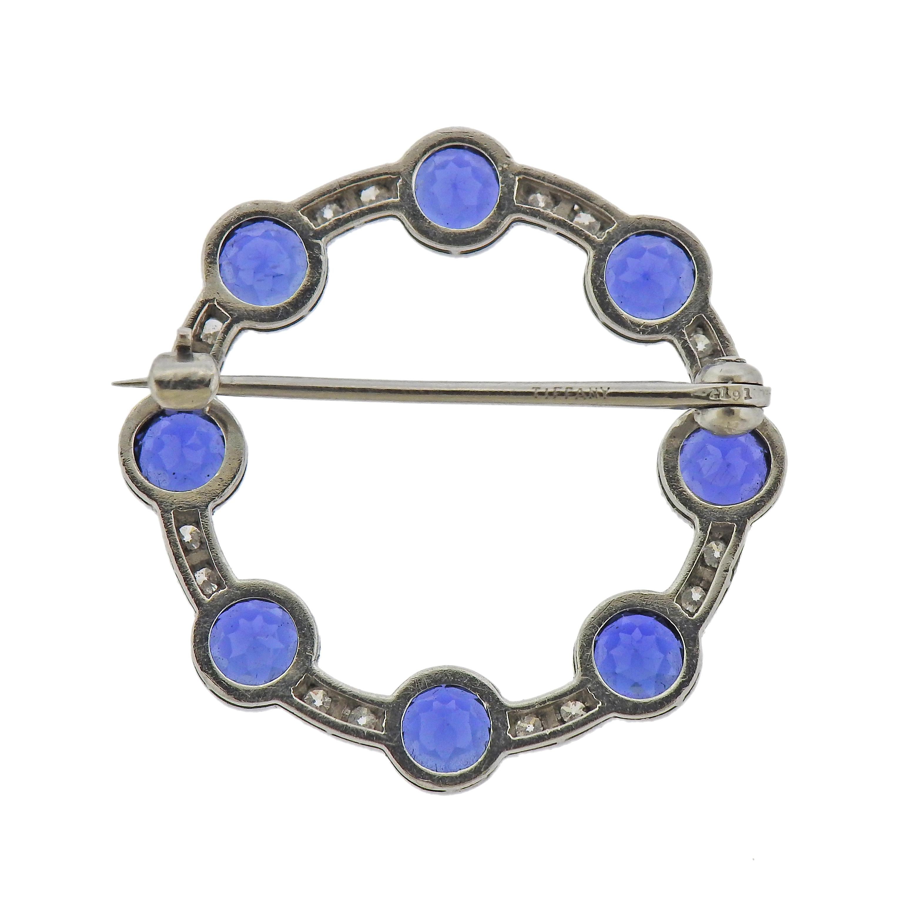 Platinum circle brooch by Tiffany & Co, with eight approx. 5mm sapphires and 0.16ctw in diamonds. Brooch is 30mm in diameter. Marked: Tiffany, 2191. Weight - 7.2 grams. 