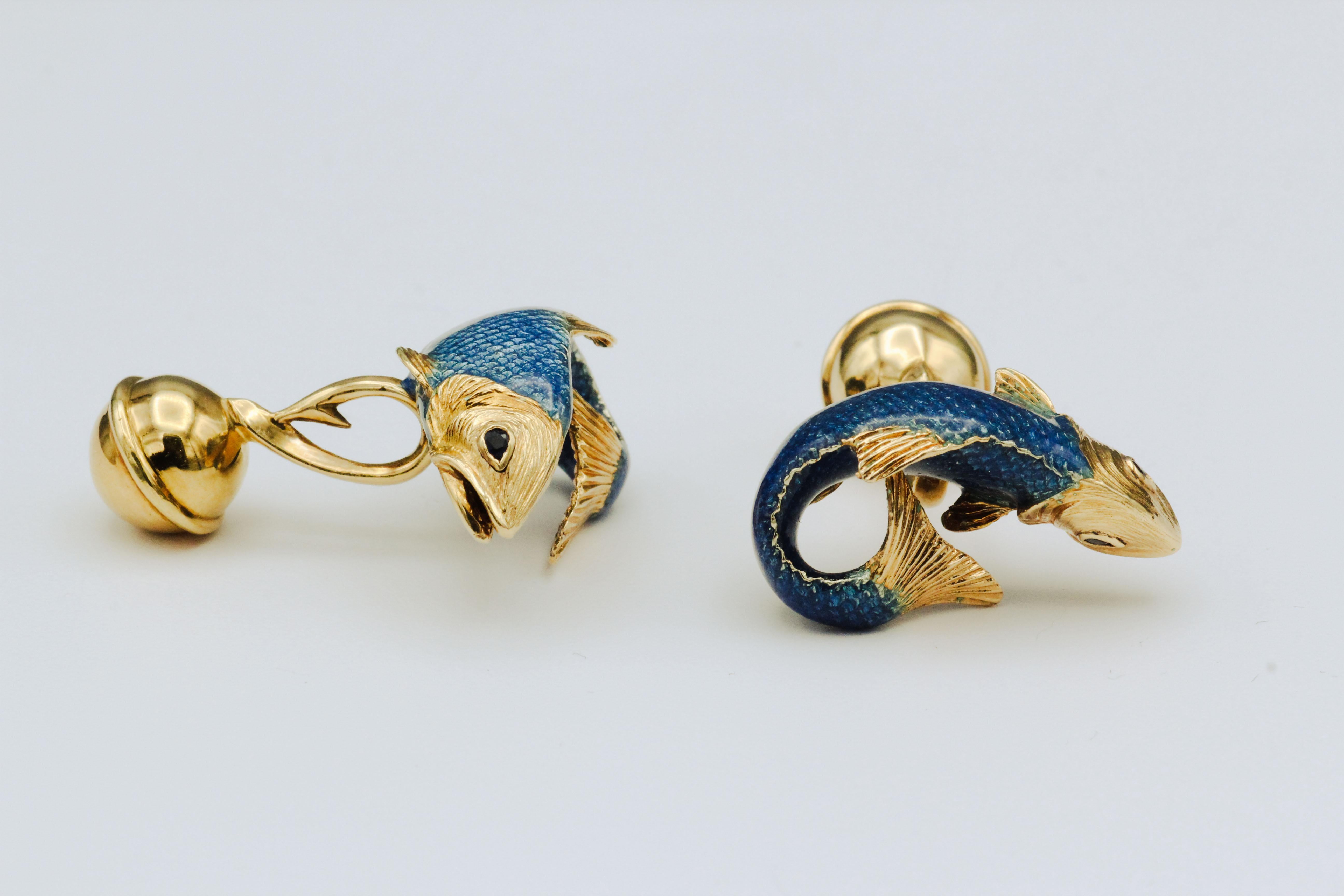 Fine pair of sapphire and 18K yellow gold Fish cufflinks by Tiffany & Co., circa 1980s. Designed as koi fish, they a further accented with sapphire as the eyes and a fine blue enamel coat.

Hallmarks: Tiffany & Co. 18k, 1989, Germany