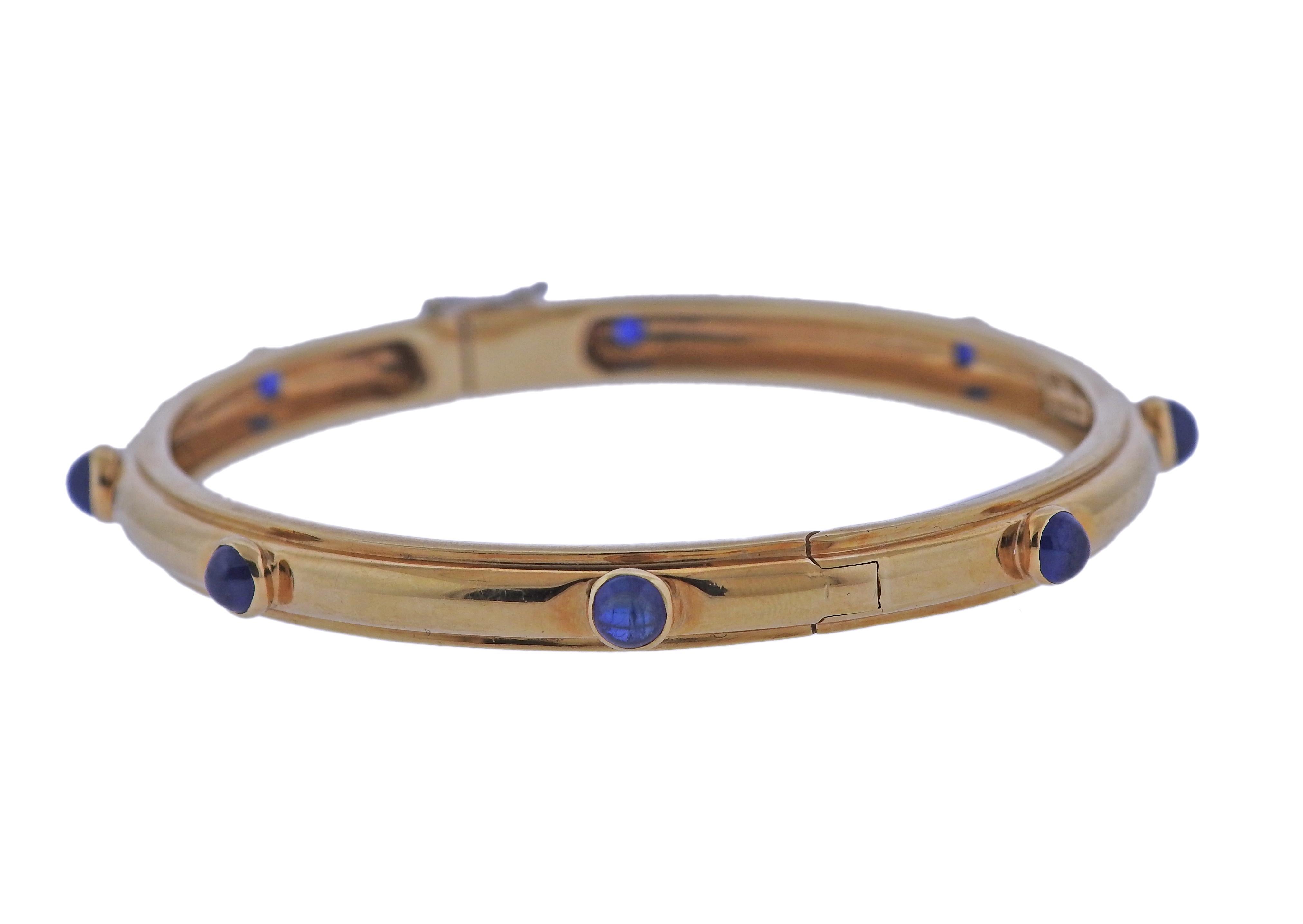 18k yellow gold bangle bracelet by Tiffany & Co, set with 4mm sapphire cabochons. Bracelet will fit up to a 7