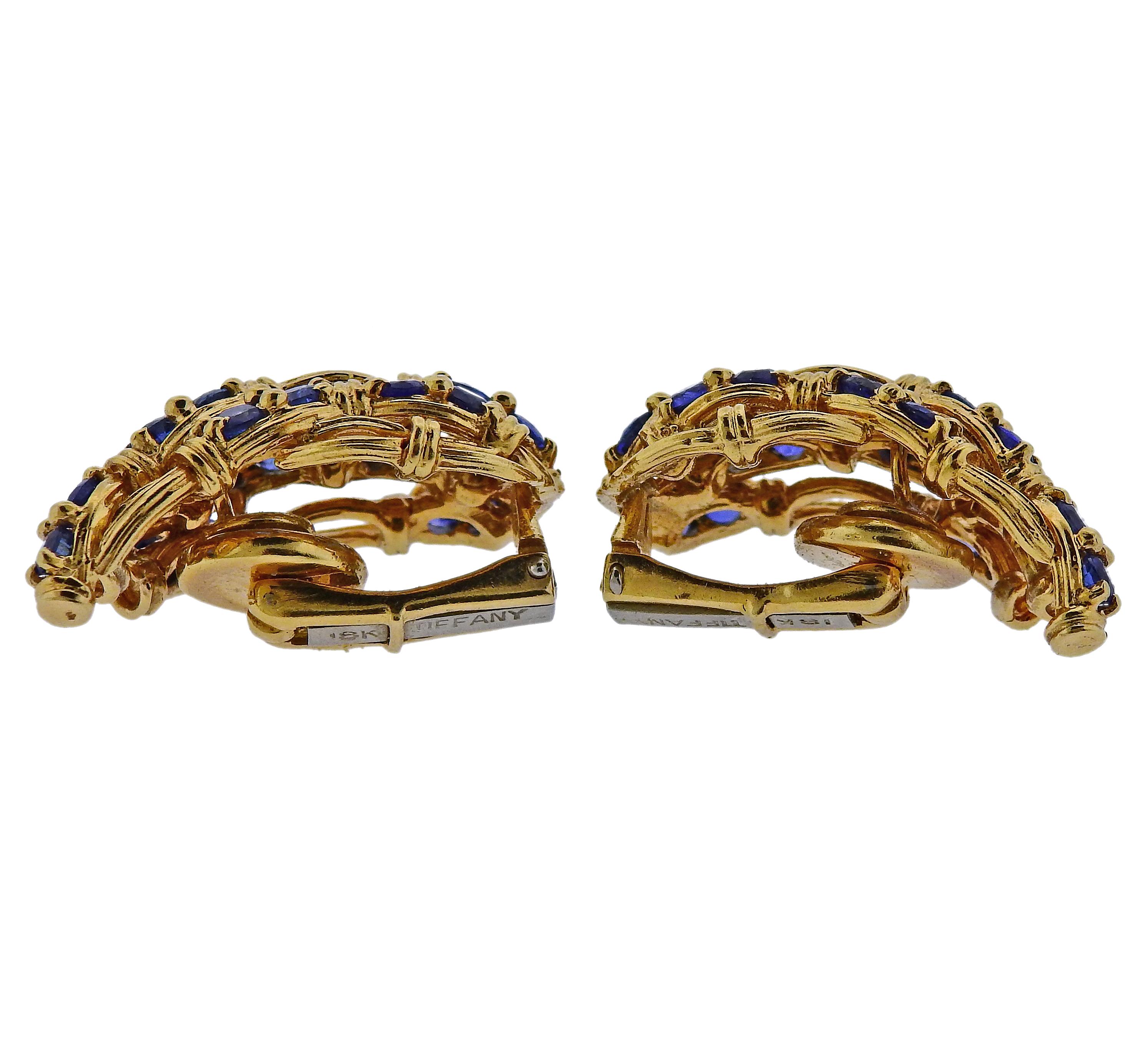 A pair of vintage 18k yellow gold earrings by Tiffany & Co, set with blue sapphires. Earrings are 29mm x 16mm and weigh 24.8 grams. Marked Tiffany 18k. 