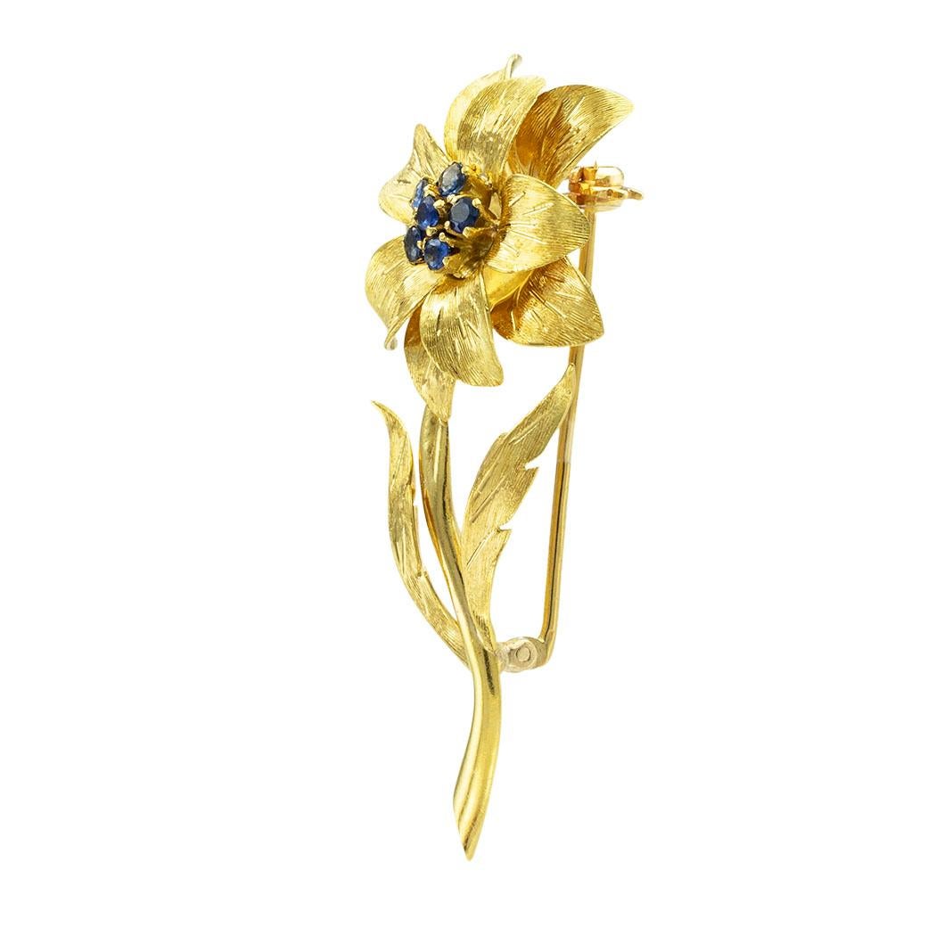 Tiffany & Co sapphire and yellow gold flower brooch circa 1960. *

ABOUT THIS ITEM:  #P5038. Scroll down for specifications.  A Tiffany & Co. creation depicting a delicate flower stem featuring a cluster of sapphires at the center of the flower