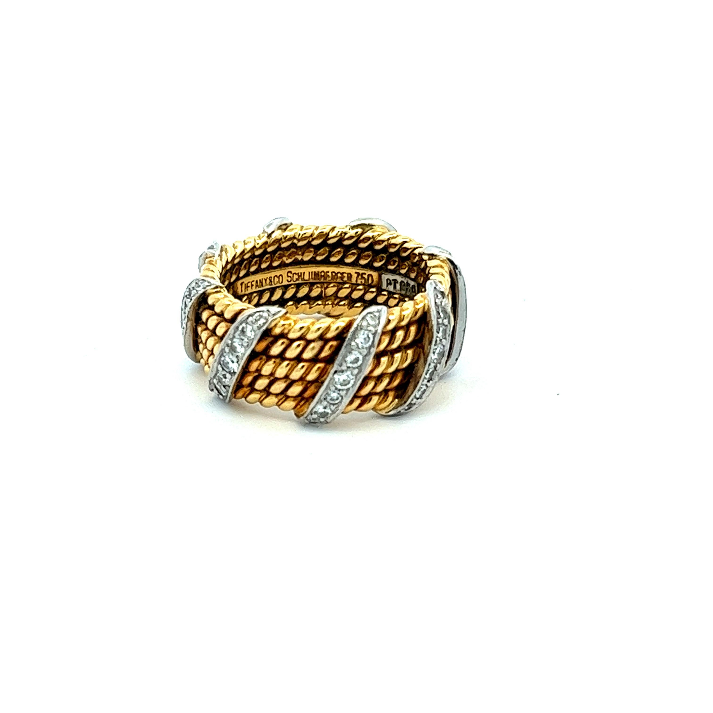 In one of the iconic collaborations with Tiffany & Co., Jean Schlumberger designed this elegant band made of 18 karat yellow gold, platinum and 0.6 carats of diamonds. The designer ring features five rows of yellow gold rope with eight stripes of