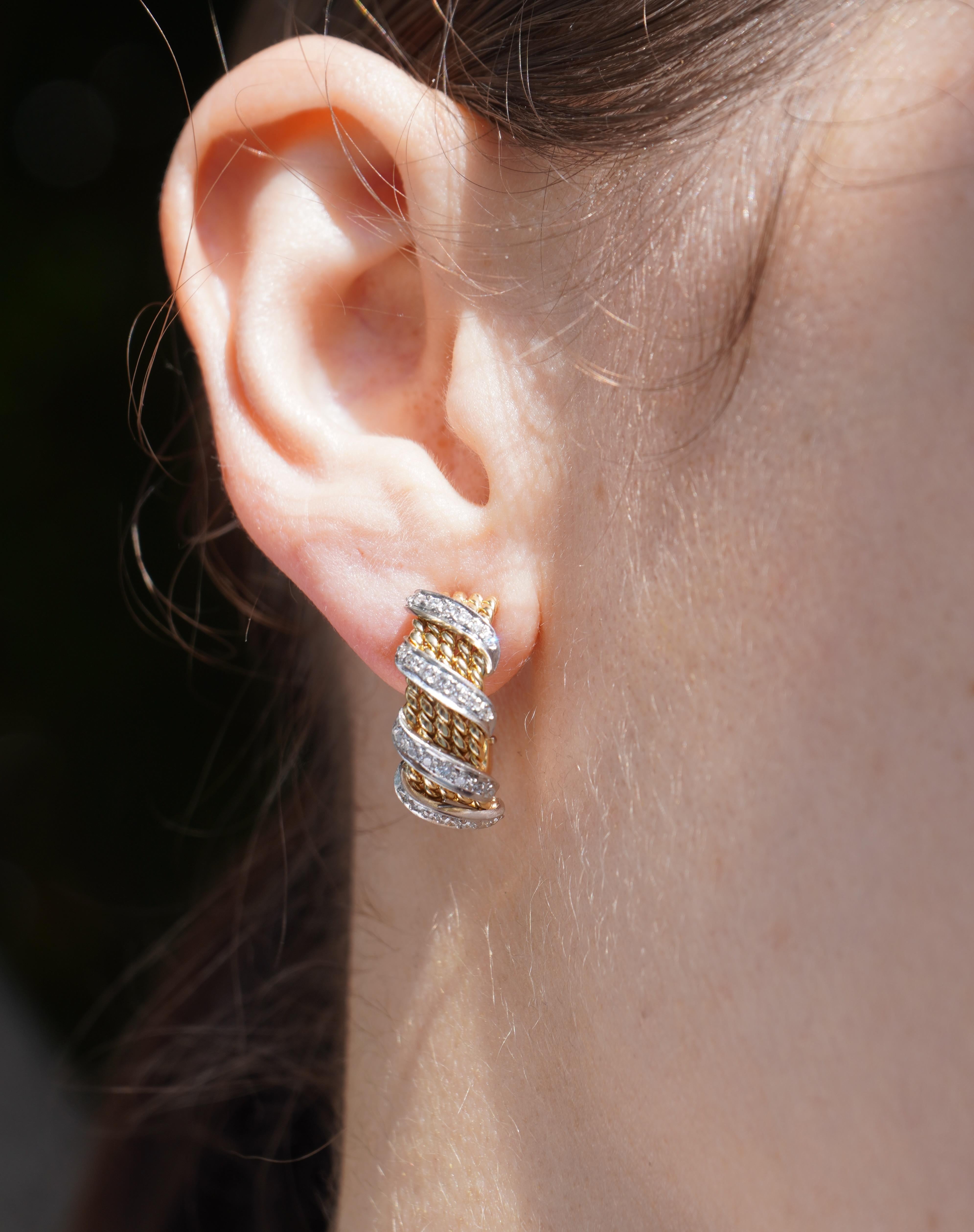 These vintage earrings by Jean Schlumberger for Tiffany & Co. are crafted in 18k gold, featuring a sophisticated design accented with diamonds. The earrings are small hoops, with dimensions of 1/2 inch in diameter, 5/8 inch in length, and 3/8 inch