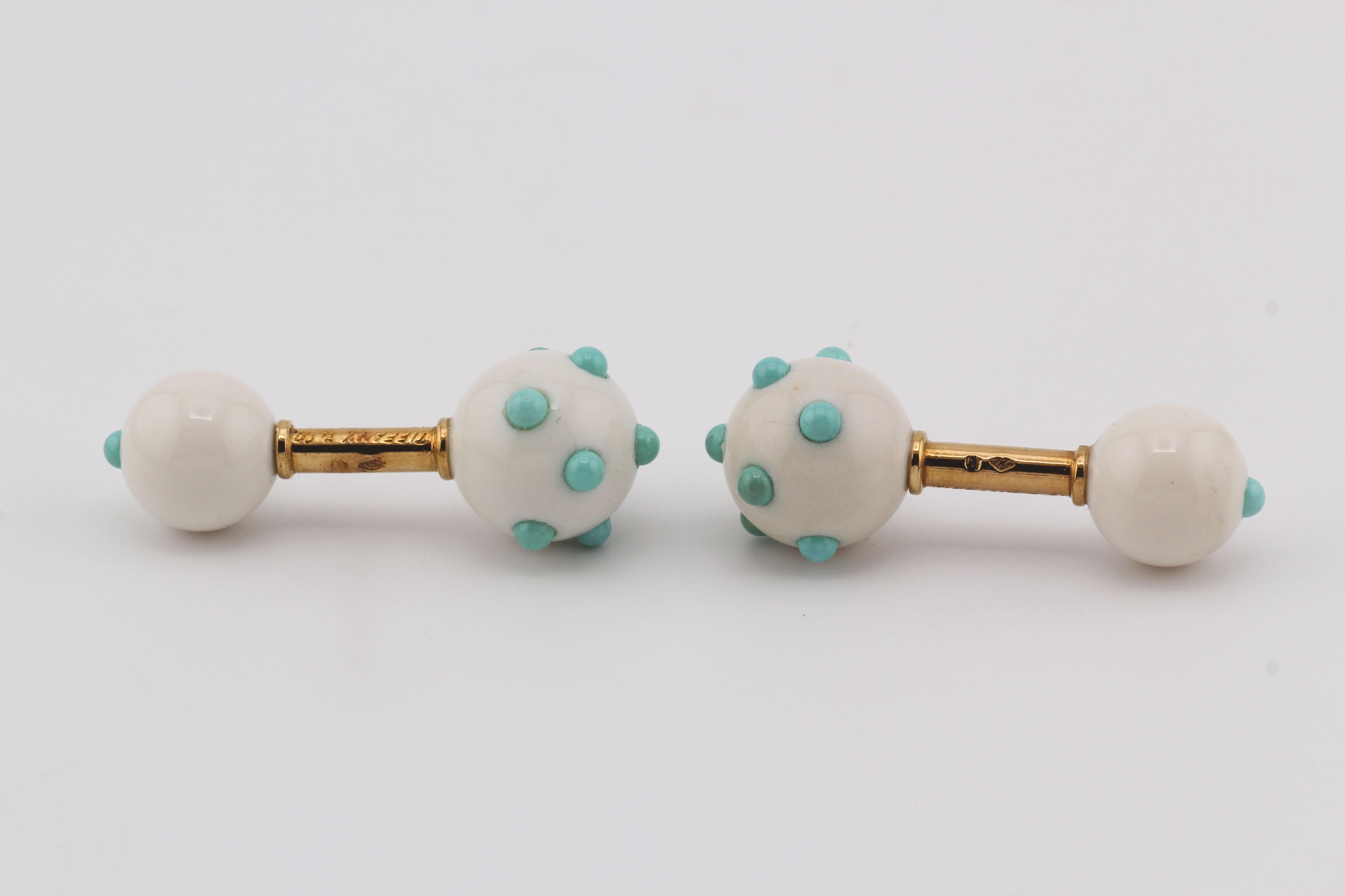 Elevate your style with the distinctive Tiffany & Co. cufflinks, a hallmark of exquisite craftsmanship and design.

Crafted from 18k yellow gold, these cufflinks feature a unique spherical design adorned with turquoise accents. The dumbbell ends are