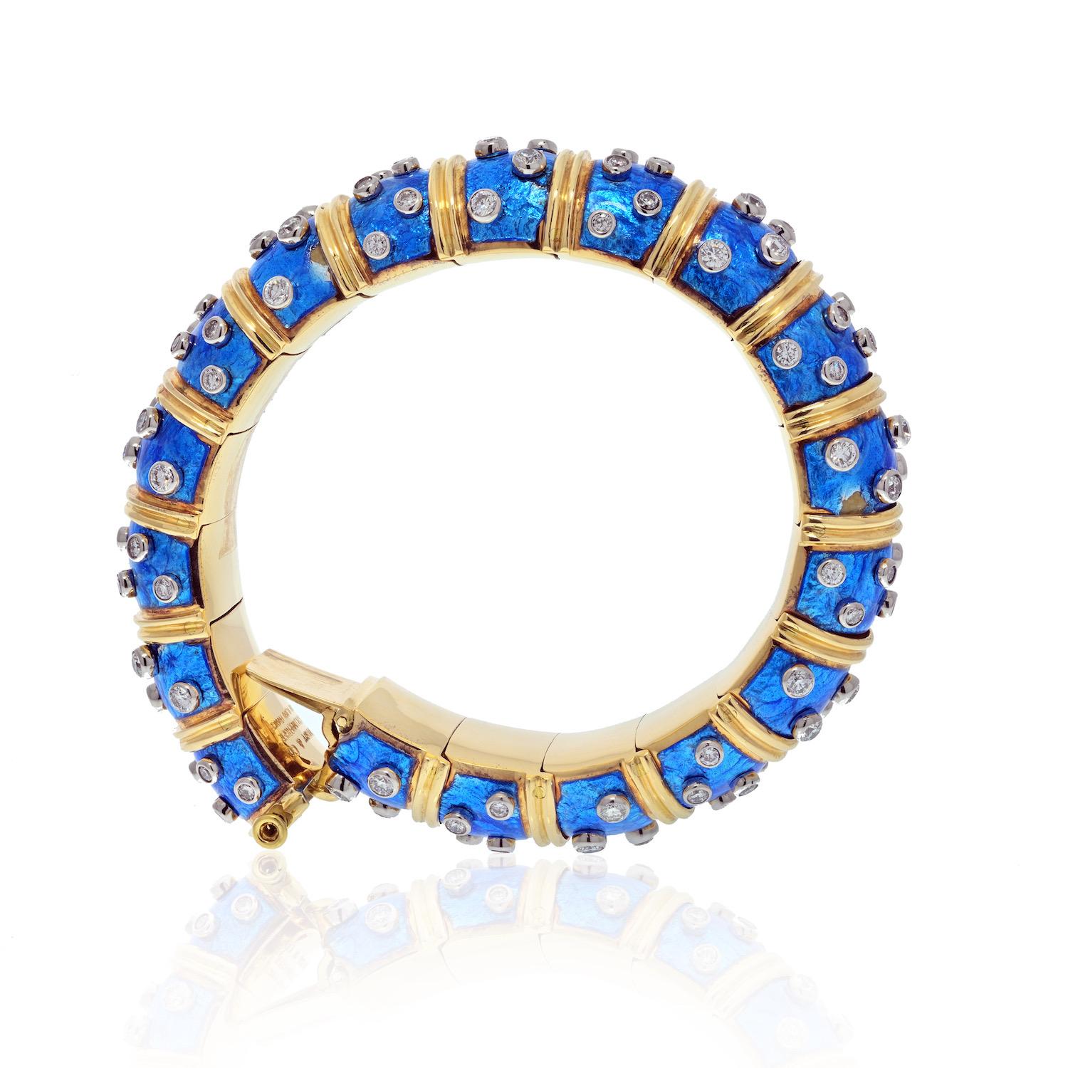 Tiffany & Co. Schlumberger Platinum & 18K Yellow Gold Blue Enamel Diamond Bangle Bracelet.
18 kt., the articulated link bombe bangle applied with blue enamel, alternately spaced by ribbed gold bands, studded with 108 collet-set round diamonds