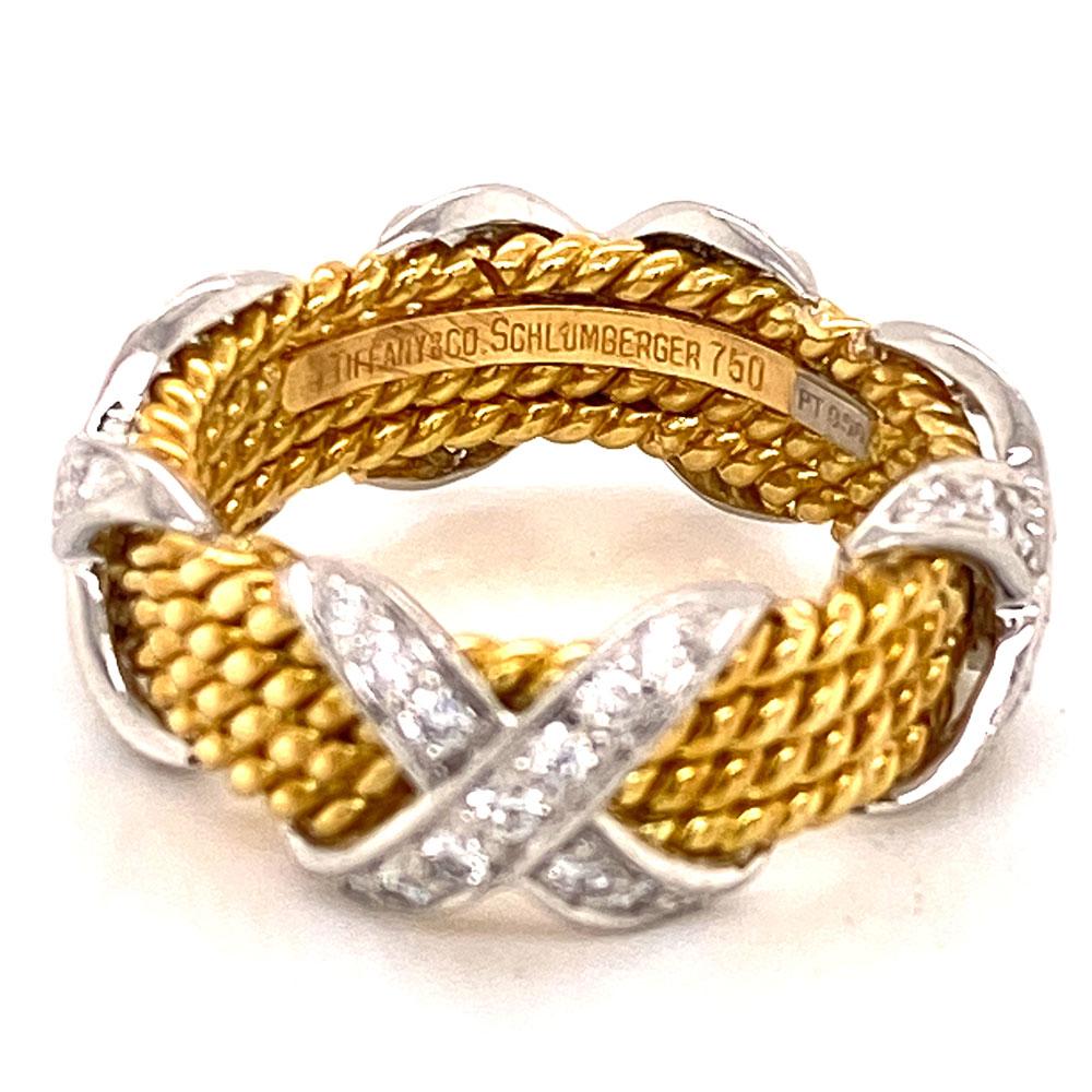 Tiffany's popular 4 row diamond X band ring by designer Jean Schlumberger. The band features 52 colorless round brilliant cut white diamonds weighing .52 CTW. The diamond X band is current on Tiffany's website. The band is size 6-6.5 and measures