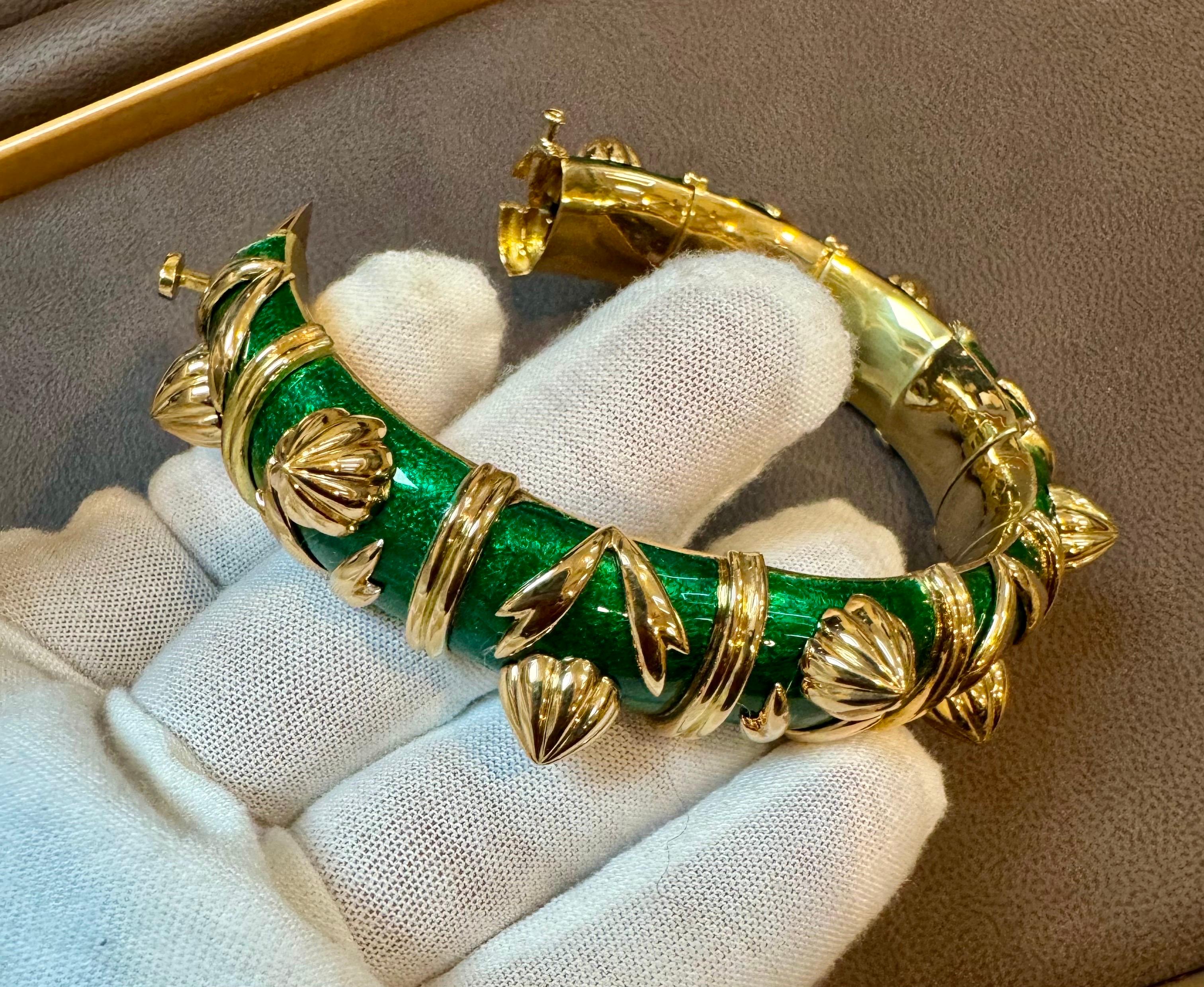 Stunning Tiffany & Co. Schlumberger Cone Losange Bracelet, crafted in 18k yellow gold and enriched with vibrant  Green enamel, accented with alternating clusters of gold leaves  and cone shape gold structures, separated by gold rings. The bracelet