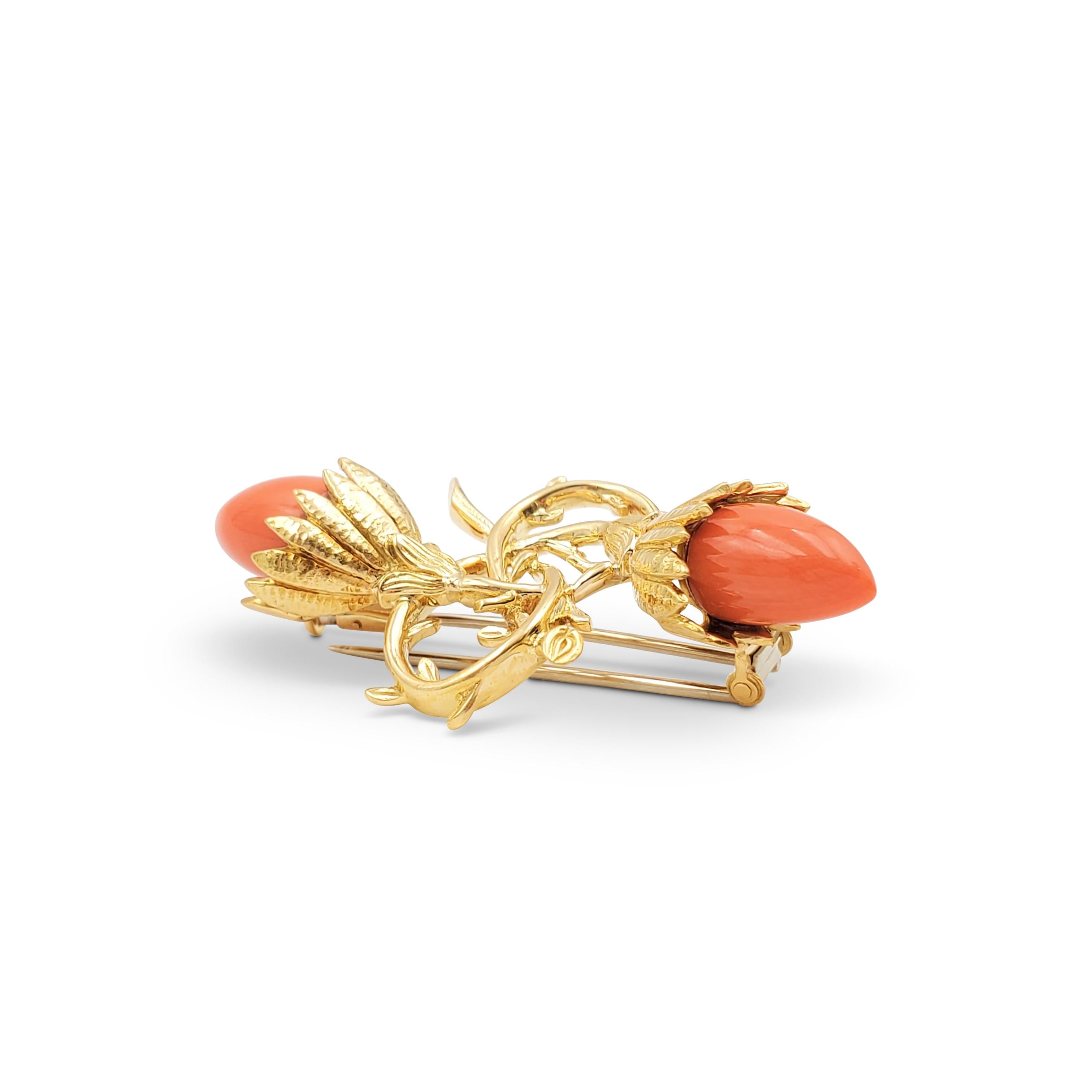 Authentic Jean Schlumberger for Tiffany & Co. acorn and foliate form brooch is set with two carved coral stones. Signed Tiffany & Co., 750, Schlumberger, with French hallmarks. The pin is presented with Tiffany & Co. pouch, no box or papers. CIRCA